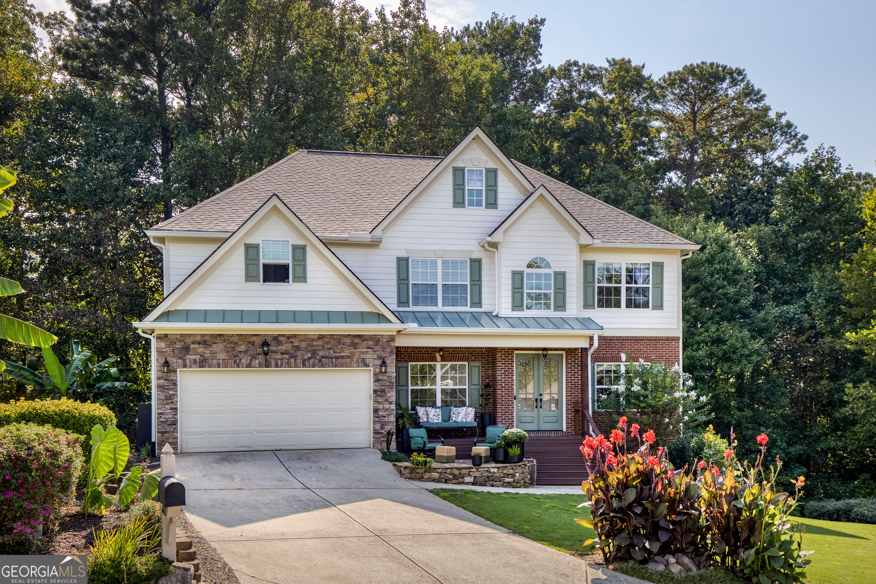 Price to move, this custom-built home sits on a roundabout cul-de-sac nestled in the mountain side of Hampton Subdivision conveniently located just off Hwy GA 400. This home has many upgrades and several favorable features. Starting with the open, covered front porch, two story foyer as you step inside, highlighting a view to the home office, formal dining room and the family room. Hardwood floors flow throughout the main and upstairs flooring. This open floor plan provides a two-story living room showcasing a stone fireplace with a custom wood mantel, custom floating shelving and cabinets, a full wall of windows, and plenty of room to entertain. A fully remodeled culinary kitchen offers; double oven, 5 burner gas stove-top with custom made vent hood and a pot filler, 3-foot sink, 7-foot custom table that seats 8, marble quartzite countertops with plenty of space to prepare a feast. A walk-in pantry with metal shelving and a restaurant style (single saloon) swinging door meet every culinary aficionado's dreams. French door to the 50 foot deck that overlooks a wooded creek and lawn area. A generously large bedroom or versatile bonus room on the main floor with remodeled half bath. The oversized laundry on the main with a wall of metal shelving, provides plenty of room for storage. 2 car garage provides easy access to the kitchen and laundry storage area and has a 60 amp EV electrical charging unit. The exquisite Owners Suite oasis awaits your very own private getaway. Owners Bathroom invites you with a jacuzzi tub, spacious tiled shower, mind blowing cabinets and countertop space with double vanity that walks you into the 2 room walk in closet. All 3 secondary bedrooms provide double door closets and tray ceilings. Lots of fun to have in the basement that features: stained concrete flooring throughout, a game room, sitting room, full bedroom with private sitting/TV area, walk in closet and full bathroom, 2 separate storage rooms, as well as 3 exterior door access to the 40-foot screened in porch. There is plenty of room to entertain with the built-in bar that overlooks the lawn and wooded creek. The backyard has a lawn area and stone patio with firepit for entertaining and plenty of storytelling under the stars. Lined with a layer of trees, this back yard provides plenty of privacy. This 6-bedroom 3 1/2 bathroom has been meticulously maintained, with countless thoughtful upgrades throughout including a doggie door in the laundry room with private steps and invisible fence to keep your fur babies from leaving the property. The neighborhood is nestled in the mountains of Forsyth County with a one road entry providing fiber/cable, clubhouse, swim/tennis, pickleball, volleyball, basketball, golf course, golf course restaurant, playground, park, neighborhood library box, sidewalks, streetlights, fishing pond and is conveniently located just off Hwy GA 400, with award winning schools and just minutes away from North Georgia Outlets. Seller is married to listing agent/realtor.