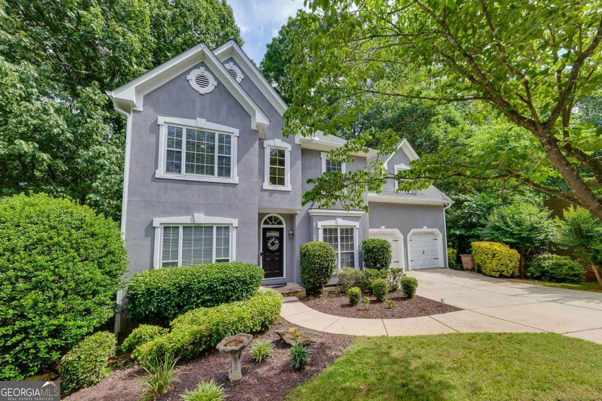 Experience the Ultimate in Outdoor Living & Privacy on the Largest Lot in Towne Lake Hills! Welcome to this exquisite 5-bedroom, 3.5-bathroom retreat, perfectly nestled on a serene, wooded 1.68-acre lot-the largest in the sought-after Towne Lake Hills, a premier swim and tennis community. Tucked away on a quiet cul-de-sac, this beautifully updated home offers an unmatched blend of peaceful seclusion and entertainer's paradise. From the moment you arrive, you'll appreciate the meticulous care this home has received-NEW roof, NEW gutters and downspouts, NEW garage doors, fresh interior paint, fresh deck stain, a newer HVAC system, and newer water heater ensure modern comfort and low maintenance. Step inside to a grand two-story foyer and stunning hardwood floors throughout. The vaulted family room with cozy fireplace flows seamlessly into the bright, updated kitchen, featuring white shaker cabinets, quartz countertops, subway tile backsplash, and stainless-steel gas appliances. The breakfast nook is ideal for casual dining and taking in the serene backyard views. But what truly sets this home apart? The unparalleled outdoor living spaces. French doors open onto a screened-in porch that becomes your private escape-ideal for morning coffee, quiet reading, or evening wine. From there, step down to a magnificent double-level deck that overlooks the expansive, tree-lined lot. Whether you're hosting a summer BBQ, an autumn bonfire, or simply relaxing in nature, this space is designed for gathering, entertaining, and enjoying ultimate privacy. Upstairs, the luxurious primary suite features a sitting area, whirlpool spa tub, and large walk-in closet. Three additional bedrooms offer space for family and guests. The fully finished basement provides even more flexibility with a bedroom, full bath, large storage area, and a private lower deck-perfect for an in-law suite, teen space, office, or media room. Located minutes from Noonday Trail, Lake Allatoona, and the vibrant shops and restaurants of Downtown Woodstock, this home offers the perfect balance of tranquil living and modern convenience. Don't miss your chance to own this private entertainer's dream! Schedule your private tour today!!!!