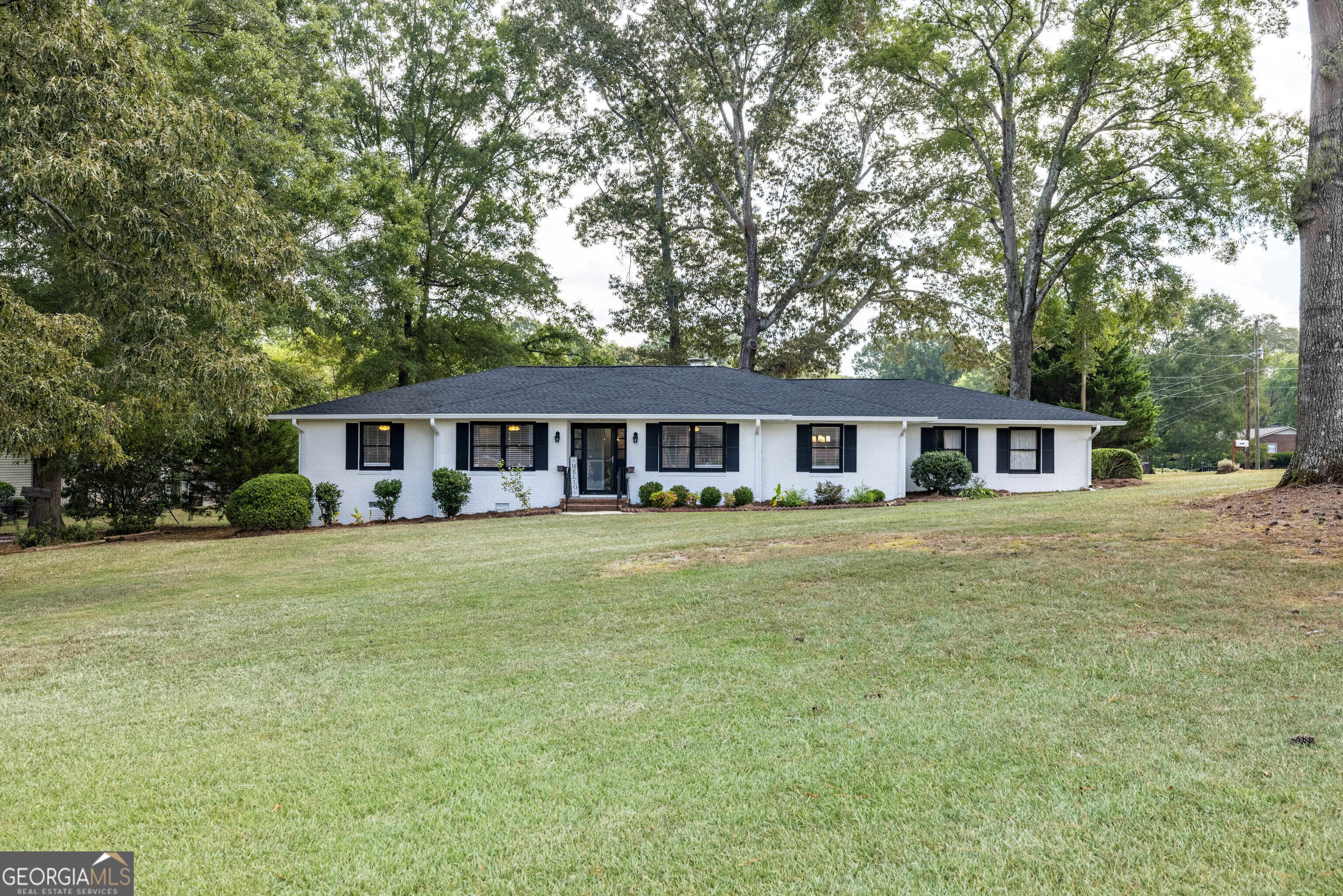 Completely remodeled brick ranch just steps from Cherokee Golf Course! This 3-bedroom, 2-bathroom home is move-in ready with all new paint, flooring, light fixtures, plumbing fixtures, doors, tankless hot water heater, and brand-new roof. The updated kitchen features granite countertops, stainless-steel appliances, and lots of cabinet space. The oversized primary suite features a large walk-in closet and a luxury tile bathroom with a 6-foot double shower, frameless glass shower door, double vanity and gold accents. The home also offers a convenient 2-car attached garage with utility room perfect for storage or a workshop. Outside, enjoy fresh landscaping, a level open yard, and an outbuilding for extra space.