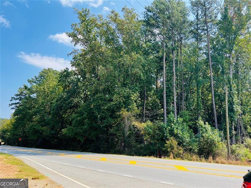 3 ACRES along the RAPIDLY evolving Winder Highway Corridor where Gwinnett County is actively investing in infrastructure and economic development! YES, this parcel sits directly within Gwinnett County's future development corridor. BUYERS, DEVELOPERS, INVESTORS seeking strategic long-term upside? GDOT is upgrading intersections and access points increasing visibility, improving traffic flow and safety both here and along the super close SR316. Offering over 300 feet of prime road frontage in Dacula, and within minutes of the transformative Rowen Knowledge Community a 2,000 acre innovation district designed to attract bioscience, tech and education-based employers - driving demand for housing, retail and services. These initiatives position this property as a strategic acquisition for developers and investors looking to capitalize on Gwinnett's next wave of growth!! This property has rezoning potential. With nearby parcels transitioning to C-2 Commercial, Mixed-Use and RM-13 Multifamily, this site could be repositioned for Townhome or apartment development, Retail or office space, Flex Commercial or Live/work units. **1 mile from Stars and Strikes Family Entertainment Center.** **Nearly directly across the street from the Dollar General store** Make us an offer!