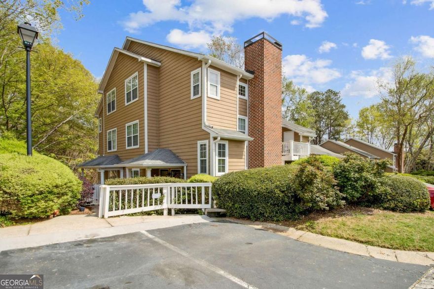 Welcome to Overlook Condominiums-where nature meets convenience in the heart of East Cobb's top-rated Walton High School district. This beautifully updated 2-bedroom, 2-bathroom condo offers an unbeatable combination of peaceful, low-maintenance living and easy access to the best of Marietta. Nestled along the prestigious Columns Drive corridor and bordered by the Chattahoochee River National Recreation Area, this home is surrounded by lush woodlands, scenic trails, and some of the area's most exclusive real estate. Inside, you'll find an inviting open floor plan with a cozy fireplace, and a sun-drenched family room that flows seamlessly into the dining area and kitchen. New floors throughout and freshly painted. The primary suite features a large walk-in closet and a private en-suite bath, while the second bedroom offers flexibility for guests, a home office, or a quiet retreat. Enjoy your morning coffee or unwind at day's end on the private, covered patio. The community offers a pool, and direct access to both the Cochran Shoals walking and biking loop and Sope Creek trails. The HOA covers water, trash, termite and pest control, landscaping, exterior maintenance, pool and tennis access, and hazard insurance-so you can focus on enjoying your lifestyle. With move-in ready comfort, proximity to great shopping, dining, and parks, this is a rare find in a truly unbeatable location