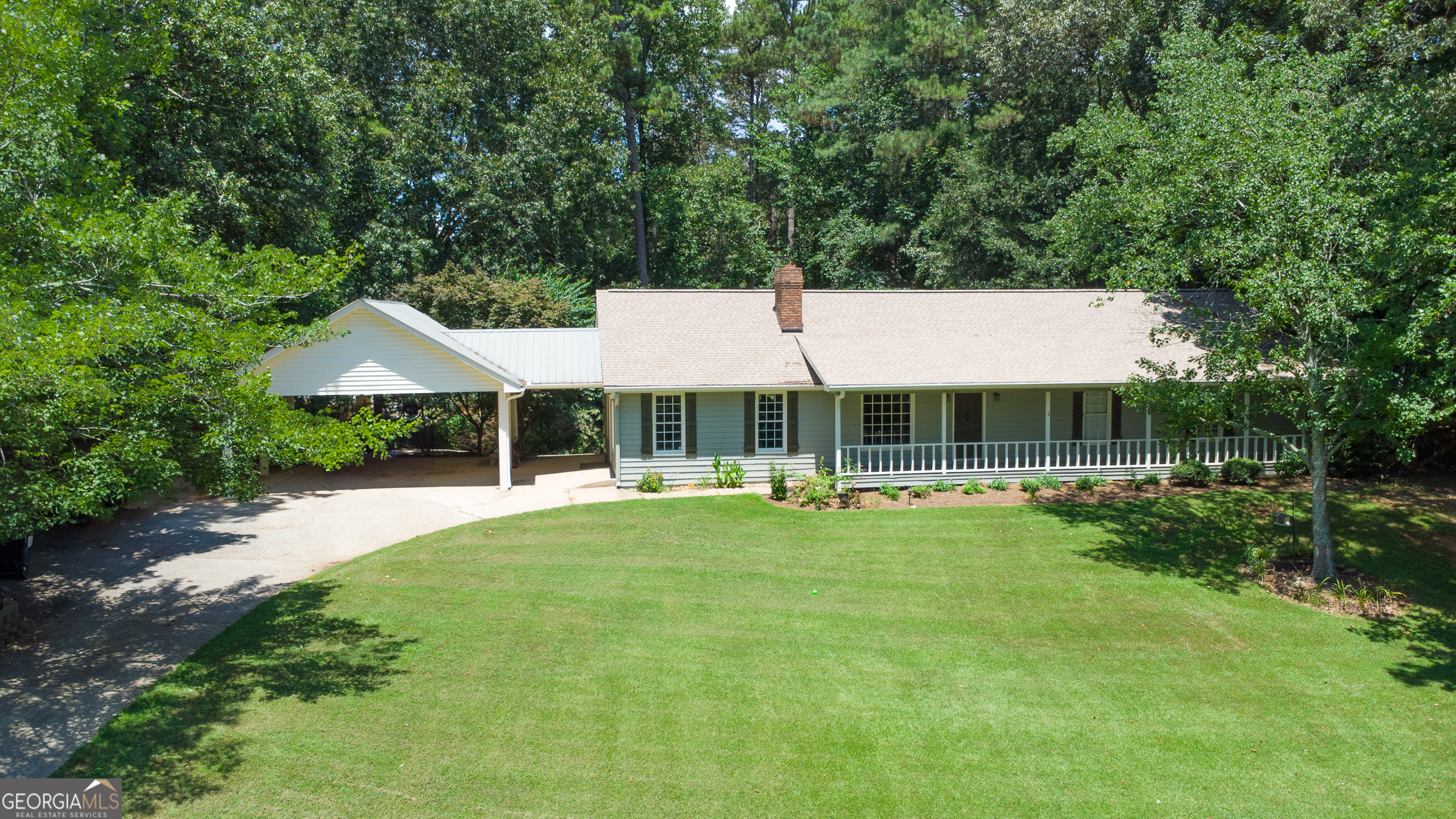 A rare and exceptional opportunity in sought-after Forsyth County! This spacious 4 bedroom, 3 bathroom ranch-style home is nestled on a private 2.5-acre lot with no HOA and no restrictions, offering the perfect blend of peaceful country living and convenient accessibility. Recently refreshed with new exterior paint and boasting a newer roof, HVAC system, and hot water heater, this home has had all the major systems updated and is move-in ready. The basement features a full bedroom, bathroom, and living room finished, making it ideal for guests, multi-generational living, or an in-law suite. There's also unfinished basement space, giving you endless potential to expand, create a home gym, workshop, or additional living areas. Outside, enjoy the serenity of 2.5 private acres - perfect for play, gardening, or simply relaxing in your own space. The oversized carport provides great entertaining space or covered parking for multiple vehicles. The shed/outbuilding offers excellent storage for tools, hobbies, or outdoor gear. This property is a rare find in Forsyth County - a hard-to-find combination of acreage, freedom, functionality, and location. Zoned for top-rated Forsyth County schools, you're also just minutes away from local parks, shopping, and dining. Whether you're looking for space to grow, entertain, or simply escape the everyday hustle, this is it and more!