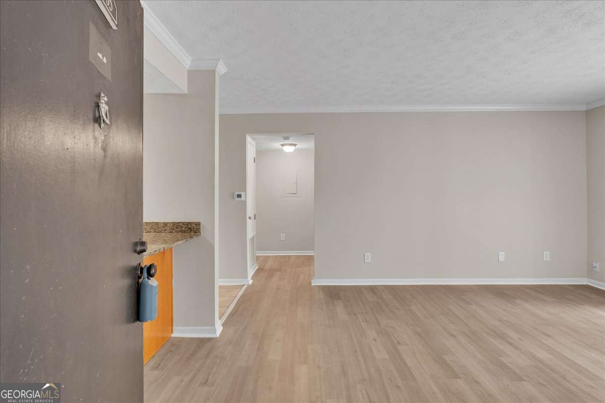Incredible and truly one of a kind move in ready condo in the heart of Vinings! Perfectly positioned in one of Atlanta's top areas that offers an unbeatable lifestyle and attractions for all to enjoy! Tucked in the highly sought after Vinings View Community features a one bed/1 bath move in ready condo located on the ground level with an impressive private wooden deck making this unit a true rare find. As you enter the front door you are greeted with a open living room with shiny and new laminate floors, fresh paint throughout and an abundance of natural lighting. The kitchen is both stylish and practical, with granite countertops, spacious cabinetry, breakfast bar and amazing views to the living room that is perfect for entertaining. The generous bedroom boasts brand new carpet, a spacious closet, and great natural light with a large window that overlooks the backyard scenery. Across from the bedroom is a lovely full bathroom with a spacious single vanity and a tub/shower combo. Newly upgraded HVAC in 2023 and the brand new washer and dryer is included! Low HOA fees and maintenance free! Community perks include swimming pool, tennis courts, fitness center, clubhouse, dog park, playground and plenty of guest parking. Unbeatable location being only minutes from Vinings Jubilee (luxury shopping & dining experience, cozy coffee shop & more), Cumberland Mall, Battery/Truist Park, and Chattahoochee River National Park. Incredibly convenient to I-75 and I-285 making commutes to the city quick, easy and stress-free. Contact us today to discover this incredible home that comes with an unmatched lifestyle!
