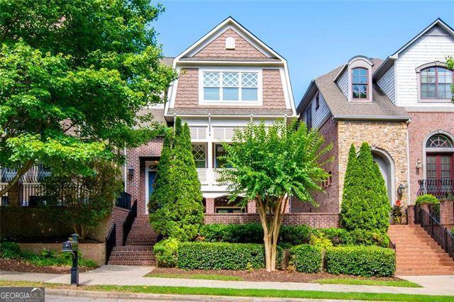Just a stone's throw away from bustling Atlantic Station, this luxurious single-family home will check all the boxes for even the most discerning occupants. Following recent renovations including resurfacing of the original hardwoods in all the main living areas, installation of plush carpeting in all bedrooms, exterior and interior painting throughout, and more, look no further - this property is ready for immediate move-in. With high-end finishes including crown molding, coffered ceilings, upgraded bath and light fixtures, and built-in shelving, this home was meticulously constructed. There are three spacious bedroom suites, each situated on their own private floor with ensuite bathrooms which makes it feel like a home within a home. Featuring an open concept that flows into the family room, dining room and one of three extra-large decks, the kitchen is adorned with beautiful, stained oak cabinetry, a huge sit-around island, premium granite countertops, and professional grade Viking appliances, including a double wall oven and warming drawer - simply an entertainer's dream! The massive owner's suite with over 800 square feet of living space, is the crown jewel of this beautifully designed home. It is complemented by beautiful trey ceilings, a quiet sitting room with a cozy fireplace, and its own private walk-out balcony. Its huge spa-quality bathroom comes with a relaxing soaking tub, granite covered dual vanities, a spacious frameless glass shower with multiple massaging body sprays, and a rejuvenating steam room with seating for two. Nestled in a quiet neighborhood within a 5-minute walk to shopping, dining, and entertainment at Atlantic Station, this home would be perfect for those who desire a balance of quiet living while being close to it all.