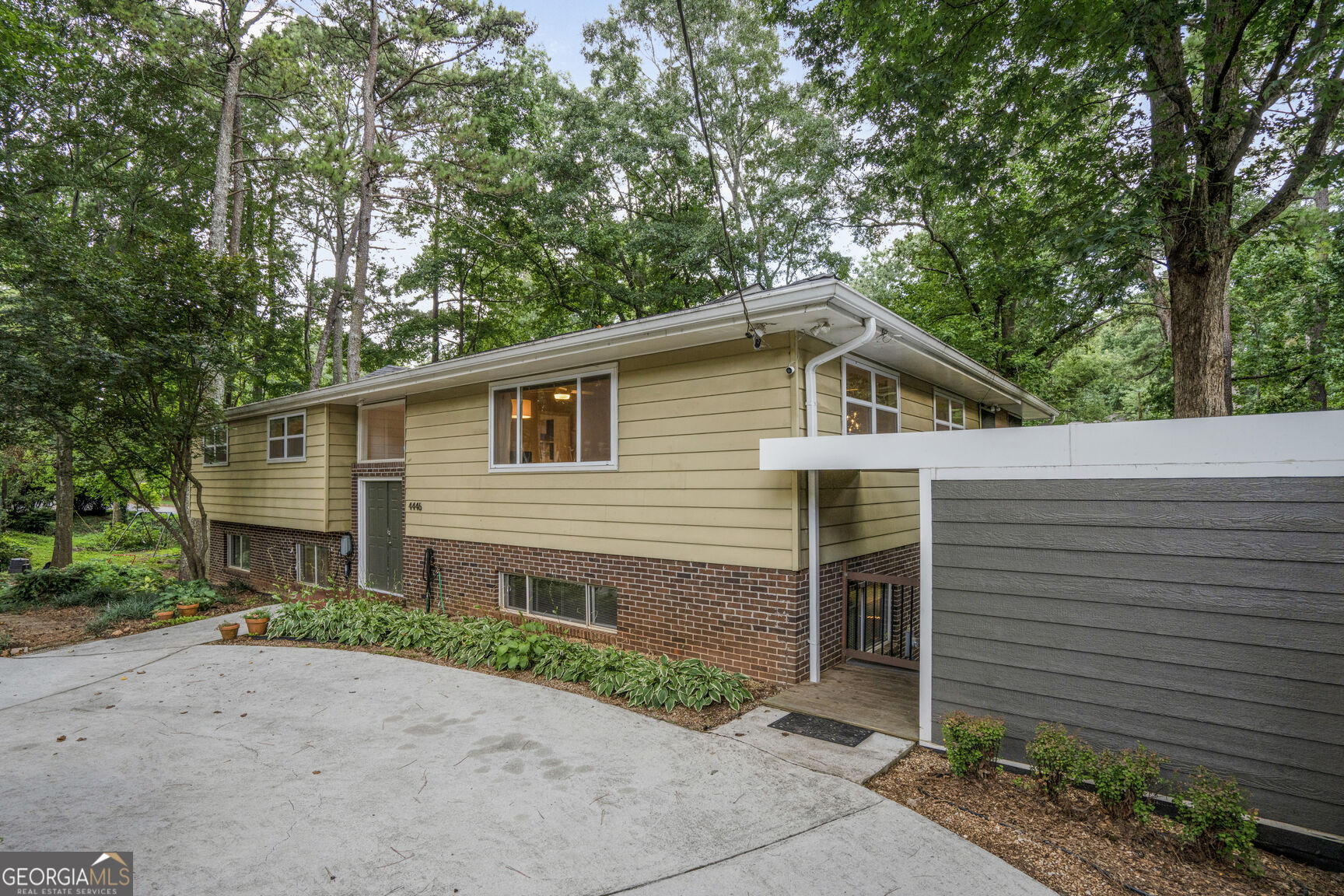 Stunning Midcentury Modern Retreat in the heart of sought after Tucker! Prepare to be wowed by this renovated 5-bedroom, 3-bath home in one of the best Atlanta suburbs nestled on an oversized lot in top-rated Livsey school district. This nature lover's dream will remind you of a treehouse with its mature trees and expansive outdoor living spaces designed for year-round enjoyment. Sip your morning coffee on one of the two large rear porches with the vaulted upper being screened-in with a premium EZE Breeze system, perfect for all seasons complete with cozy gas fireplace. Inside, the spacious living area boasts a midcentury modern flair, flooded with light from the large windows. The renovated kitchen flows effortlessly into the living and dining areas, perfect for entertaining. Lower level includes comfortable living space, 2 bedrooms, laundry and a full second kitchen, ideal for guests, multigenerational living, or rental potential. Enormous storage/utility space on the lowest level. With convenient dual driveways, front and rear, there is plenty of parking. This rare property combines style, space, and a peaceful natural setting, all just a stone's throw from Tucker's vibrant energy and amenities, shops, restaurants, parks, and the beloved Chili Cook-Off! Convenient to all highways for easy access to downtown Atlanta, Decatur, and Stone Mountain.