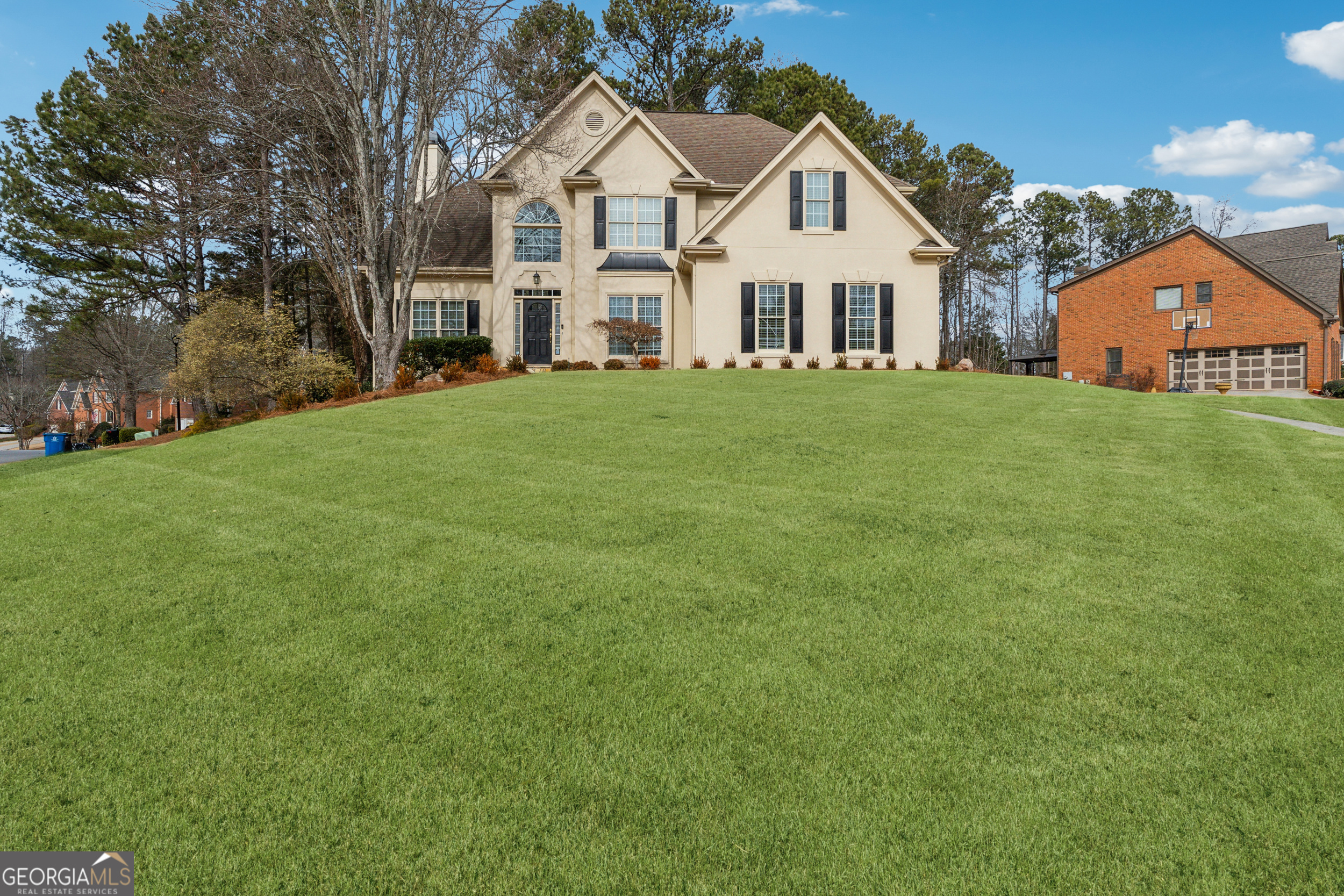 Nestled in the highly sought-after Windward Community in Alpharetta, GA, this beautiful custom 6-bedroom, 4-bathroom home offers the perfect blend of luxury, comfort, and convenience. Situated in a top-rated school district, this home is ideal for anyone. On the main level, you'll find a spacious guest bedroom and full bath, providing a comfortable retreat for visitors. Upstairs, the expansive primary suite features a double vanity, a soaking tub, and a separate showerCoperfect for unwinding after a long day. The fully finished terrace-level basement is an entertainer's dream, with plenty of room for gatherings, a home theater setup, and additional living space. Throughout the home, every detail has been thoughtfully upgraded, including hardwood floors in all the bedrooms and stairways. The open, two-story family room flows seamlessly into the chef's kitchen, which boasts double ovens, modern finishes, and ample space for meal prep and entertaining. To ensure comfort and accessibility, the home features wider stairways and hallways, making it easy to navigate, and the basement stairs are equipped with a mechanical lift system for added convenience.This stunning home is truly move-in ready, offering modern upgrades and a welcoming atmosphere throughout.