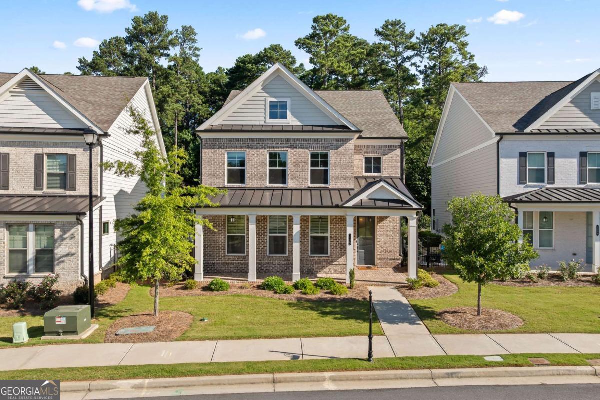 Welcome to this thoughtfully designed home that blends comfort, functionality, and style in one of Suwanee's most desirable communities. Step into a spacious, open-concept layout featuring a bright and inviting foyer that flows seamlessly into the expansive family room, dining area, and chef-inspired kitchen. Perfect for entertaining, the kitchen showcases an oversized island with ample seating, stone countertops, and a clear view of the main living space. A private guest bedroom and full bath on the main level offer ideal accommodations for visitors or a home office setup. Upstairs, retreat to the luxurious owner's suite with dual walk-in closets, a spa-like bathroom featuring double vanities, and plenty of natural light. Two additional bedrooms are connected by a convenient Jack-and-Jill bathroom, making this layout perfect for families or roommates. Enjoy resort-style living with exceptional community amenities, including a gated entrance, swimming pool, cabana, five charming pocket parks, and direct access to scenic county park trails-plus a private path leading to Peachtree Ridge Park. Located within the highly sought-after Peachtree Ridge School District, this home offers not just beautiful interiors but also a top-tier lifestyle. You're only 3 miles from the vibrant Suwanee Town Center, known for its dining, shopping, festivals, and family-friendly atmosphere. Don't miss your chance to live in Ellington, where convenience meets elegance in the heart of Suwanee.