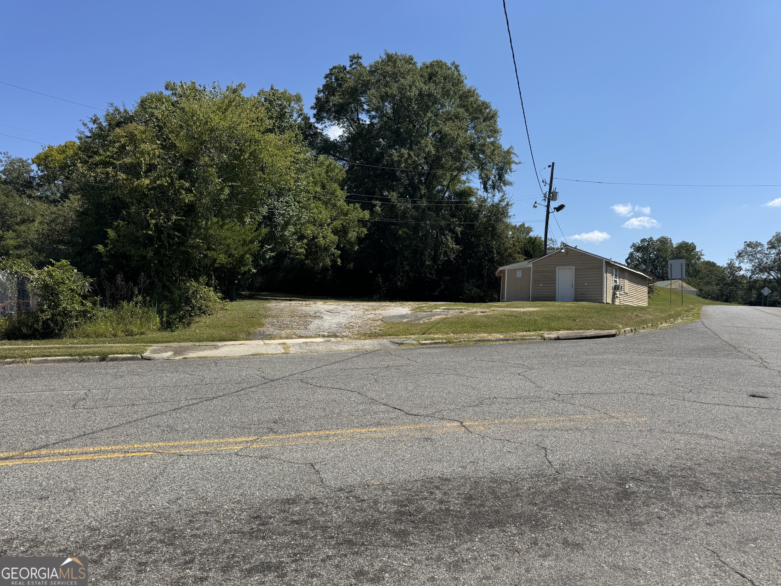 This prime commercial opportunity combines two highly visible parcels at 1000 Vinson Hwy (GA-112) and 1070 S Jefferson Street in Milledgeville, GA. Together, the properties offer exceptional road frontage and outstanding visibility for any business seeking a location designed to be noticed. Positioned along GA Hwy 112, one of the most heavily traveled routes connecting Milledgeville to the Fall-Line Freeway, the site benefits from a steady stream of local and regional traffic. The highway passes directly through Renaissance Park, the centerpiece of redevelopment at the historic Central State Hospital campus, placing these parcels at the heart of one of Middle Georgia's promising growth areas. Both parcels are zoned Community Commercial within the City of Milledgeville, offering a wide range of development possibilities from retail and services to mixed-use ventures. The existing 648-square-foot structure on-site provides a starting point that could be incorporated into future plans, serving as the backbone of your new business endeavor. With strong traffic counts, excellent exposure, and proximity to an area of major revitalization, this property represents an ideal opportunity to establish or expand your presence in Milledgeville's growing market.