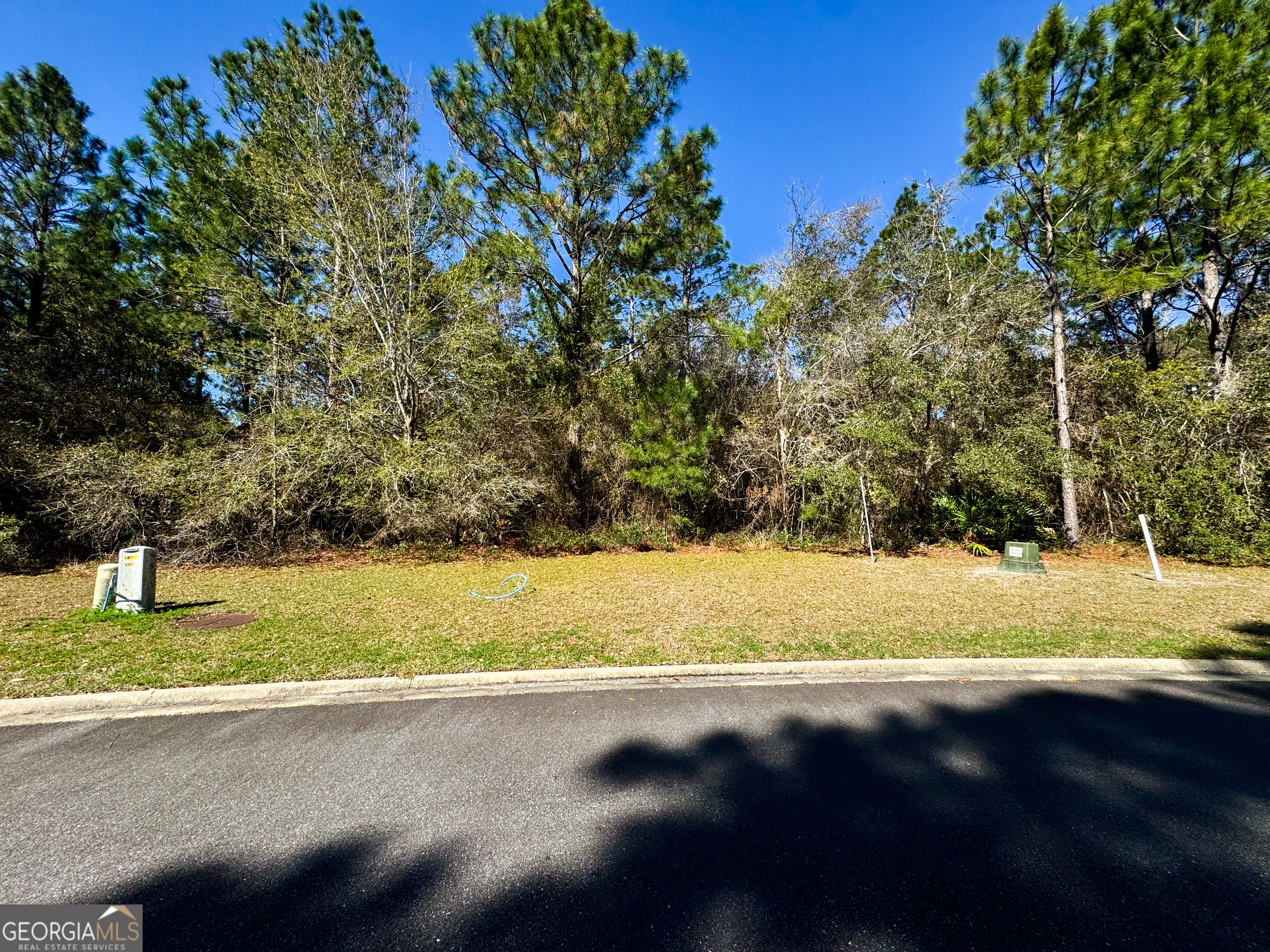 Nestled within the prestigious gated community of Cumberland Harbour in historic St. Marys, Georgia, this prime building lot offers an unparalleled opportunity to create your dream coastal retreat. Surrounded by lush greenery and scenic waterways, this highly sought-after community provides the perfect blend of privacy, luxury, and outdoor adventure. Residents enjoy world-class amenities, including tennis courts, pickleball courts, a croquet lawn, a basketball court, three resort-style swimming pools, and a fitness center. For water enthusiasts, a day dock offers convenient access for kayaking, paddleboarding, and daily boat parking. Miles of scenic walking and biking trails wind through the community, immersing residents in the natural beauty of the coastal environment. Cumberland Harbour is perfectly positioned near the Intracoastal Waterway and the Atlantic Ocean, making it a haven for boaters and outdoor lovers. Just minutes from historic downtown St. Marys, residents can explore charming shops, local dining, and the Cumberland Island National Seashore. Easy access to Jacksonville International Airport ensures seamless travel. Whether you're looking to build a permanent residence or a seasonal retreat, this homesite offers the best of coastal living in one of Georgia's premier master-planned communities. Must be accompanied by a licensed GA realtor to enter the community. Contact us today to schedule your private tour!