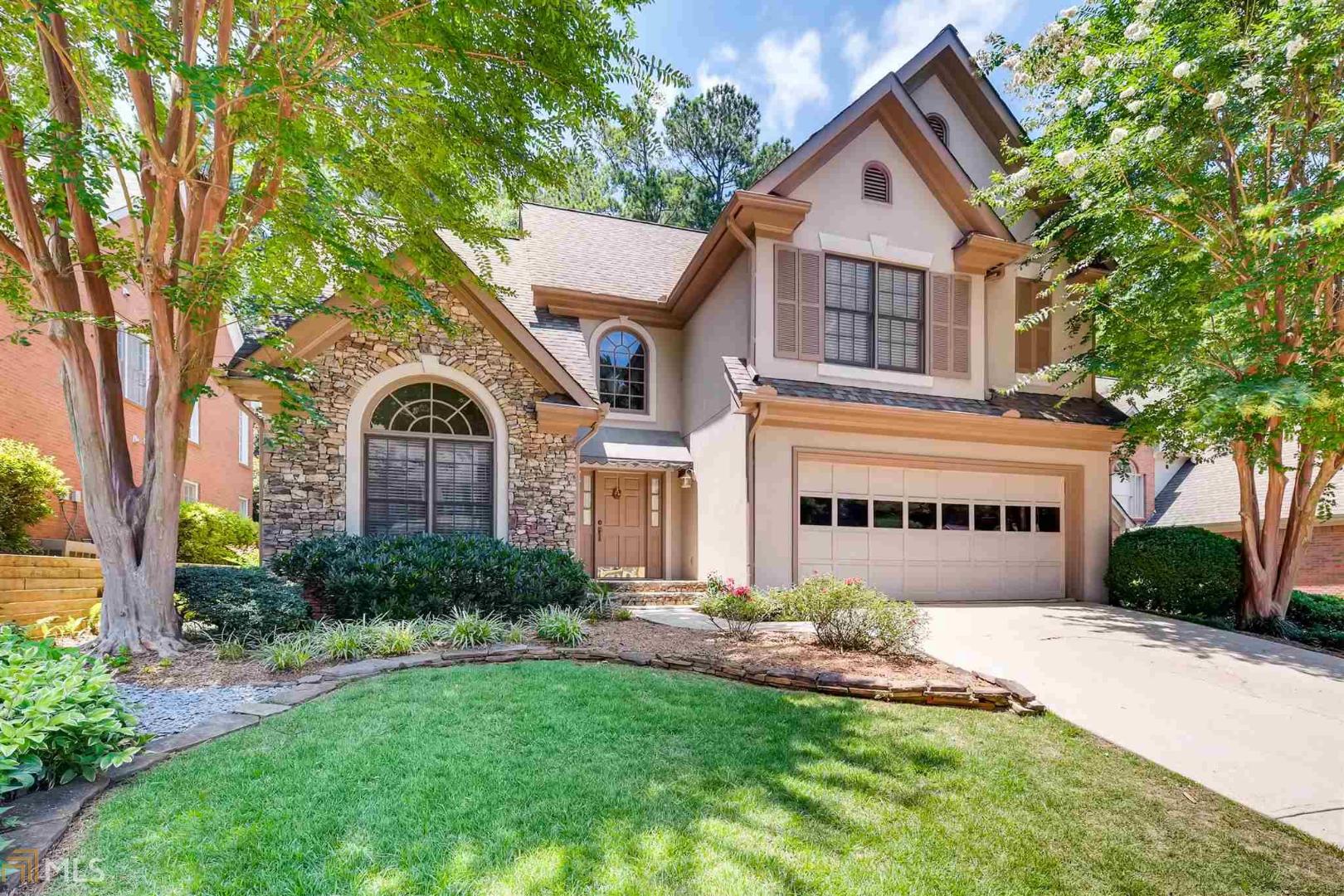 Gorgeous, bright and spacious home on a beautifully landscaped lot! Perfect location with easy access to I-85 and I-285. Amazing floor plan with soaring Living Room open to formal Dining Room, 2-story height Family Room with gas fireplace, and recently updated Kitchen with white onyx Corian countertops. Kitchen nook has perfect background with windows looking out to huge deck with covered trellis, perfect for entertaining or dining outside. Large Master Suite with sitting area overlooking the backyard. Wonderful and friendly cul-de-sac neighborhood. COME AND SEE!