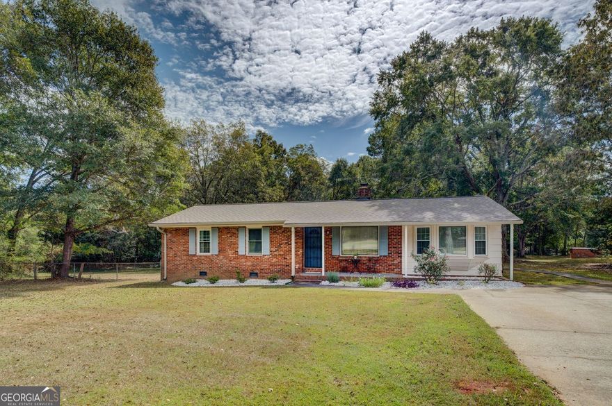 Welcome home to this charming and well-maintained 4-bedroom, 2-bath home perfectly situated on nearly an acre (0.96) of land. You'll love the cozy feel and thoughtful updates throughout - including new gutters,  and an HVAC system that's serviced annually for peace of mind. The home is on a private well.  Inside, you'll find a warm and inviting layout accented by a beautiful brick wall feature that adds character and charm. The fenced backyard offers plenty of space for outdoor living, gardening, or pets to play. With its great condition and spacious lot, this adorable home offers the comfort of country living with easy maintenance and pride of ownership throughout.  Hurry, this home will not last long!