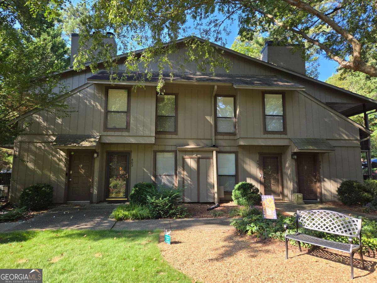 Welcome to this stunning, updated 1-bedroom, 1-bath condo in the highly desirable Vinings Run community of Smyrna! Nestled at 403 Cumberland Court SE, this 905 sq ft gem has been meticulously renovated, blending modern elegance with serene suburban charm. Step inside to discover a fresh, open-concept layout featuring brand-new luxury vinyl flooring throughout, crisp white cabinetry in the galley kitchen, sleek stainless steel appliances, and a stylish breakfast bar perfect for casual dining or entertaining. The spacious living area boasts built-in bookcases, a cozy fireplace for those cool evenings, and seamless flow into the separate dining space-all overlooking the lush, landscaped courtyard just outside your door. Retreat to the expansive primary suite, complete with two closets and a fully remodeled bath with a tub/shower combo and contemporary fixtures. Enjoy outdoor bliss on your oversized covered deck, ideal for morning coffee or evening relaxation amid the wooded, private surroundings. This turnkey condo offers resort-style amenities including swimming pools, tennis courts, and dog parks, plus unbeatable convenience near I-75 and I-285, top dining and shopping, Truist Park, The Battery, Silver Comet Trail, and more. With fresh paint, updated lighting, high-speed internet readiness, and energy-efficient insulated windows, it's truly move-in ready. Don't miss this prime opportunity in a vibrant community-schedule your showing today! Also, No Rental Restrictions!!