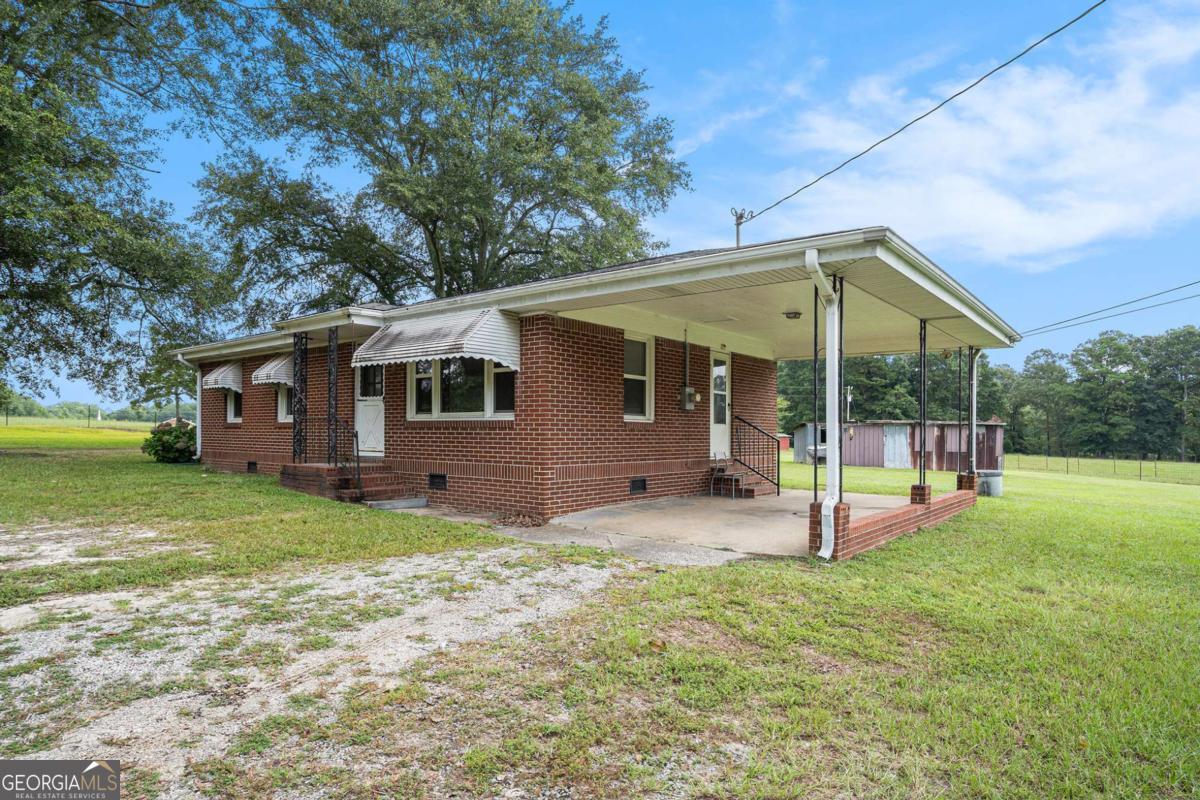 Charming Brick Ranch with Great Bones and Timeless Character - No HOA! Welcome to 2607 Highway 101 - a classic, four-sided red brick ranch offering potential and charm, situated on a peaceful and level 0.75-acre lot. With only one owner since it was built, this well-loved home is full of character, including peppermint-colored awnings that add a bright, welcoming touch. Inside, you'll find original resurfaced hardwood floors, a cozy eat-in kitchen, and a generously sized family room. The bathroom features a resurfaced tub, updated vanity, and new toilet. While the home could use a few personal touches, it stands on solid bones with major system updates already completed: New roof (2020) New windows (2006) Updated electrical wiring Water heater (2010) HVAC system (2013) A tall-ceiling carport provides covered parking, and the surrounding land is privately owned, enhancing the quiet, country-like setting. No HOA means more freedom to make it your own. There's enough space in front of the carport to park several vehicles. This home is ideal for a first-time buyer, down-sizer, or savvy investor looking for a low-maintenance property with room to build equity. With its combination of charm, privacy, and practicality, 2607 Highway 101 is a rare find that's ready for its next chapter. 2607 SR-101 Villa Rica, GA 30180 United States