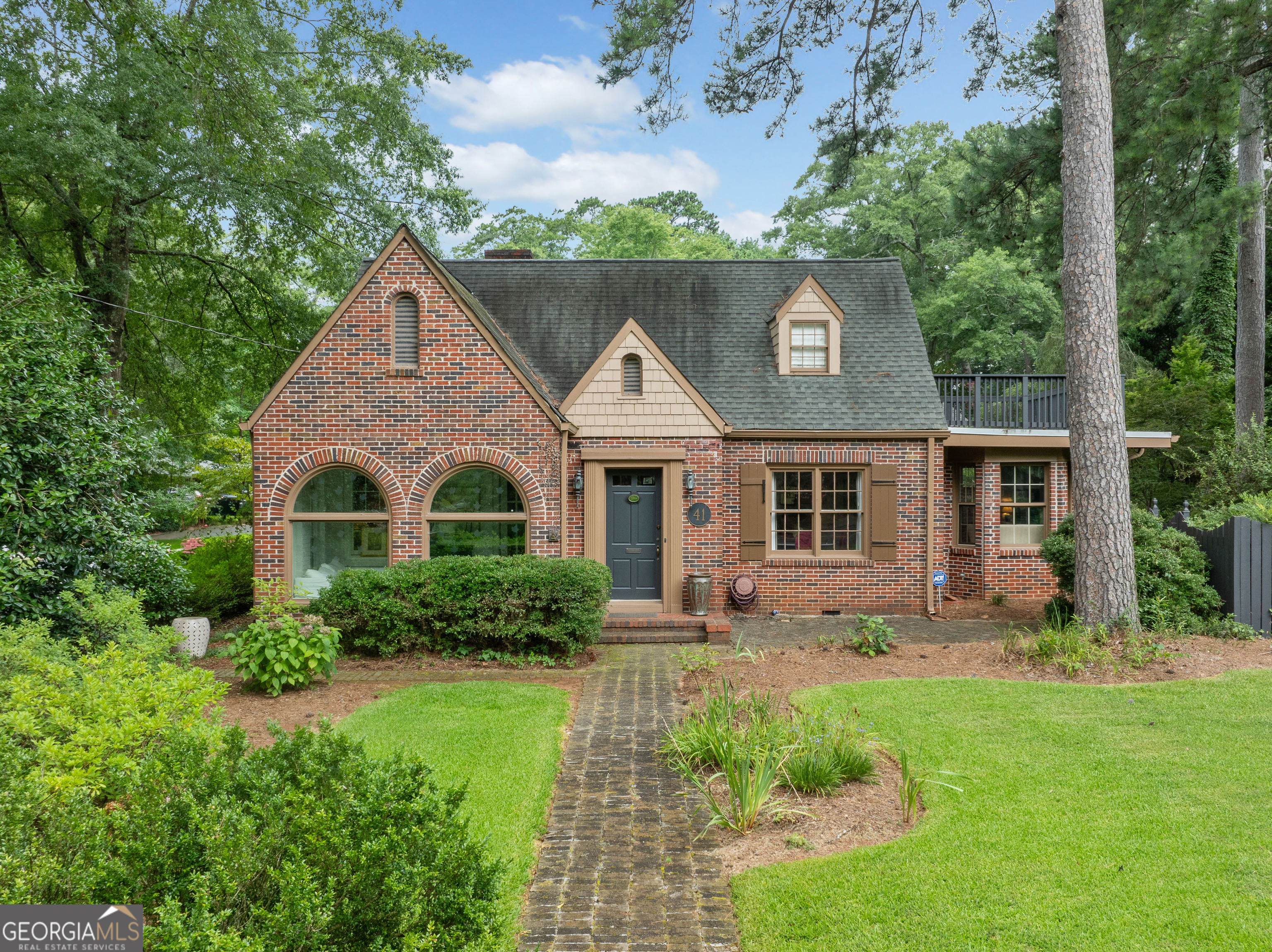 Step into timeless charm and modern elegance with this stunning original Avondale Estates all-brick renovated cottage in the heart of Historic District. Perfectly perched on a beautifully landscaped corner lot, this home is surrounded by gardens, some secret, with well designed paths, a brick patio ideal for gatherings, and a detached two-car garage complete with a bonus space-recently used as a super cute potting shed. Inside, natural light floods the glassed-in east-facing sunroom, leading into a lovely living room with built-in bookshelves, a cozy fireplace, and beautiful hardwoods. The separate dining room adds a touch of formality, while thoughtful details like crown molding and striking light fixtures elevate every space. The kitchen is a true showpiece, featuring unique stone floors, stone countertops, custom cabinetry, and stainless steel appliances-all designed with both cooking and entertaining in mind. A charming mud room tucked beside the kitchen hides the washer and dryer and adds functionality without sacrificing beauty. Upstairs, retreat to the luxurious primary suite with access to a rooftop space plus an updated perfectly appointed bath, double vanity, dressing area, and expansive walk-in closet. Just one block from Avondale's thriving downtown-home to restaurants, shopping, and the vibrant town green-this home isn't just a place to live, it's a lifestyle. Come see what all the excitement is about at 41 Clarendon in Avondale Estates.