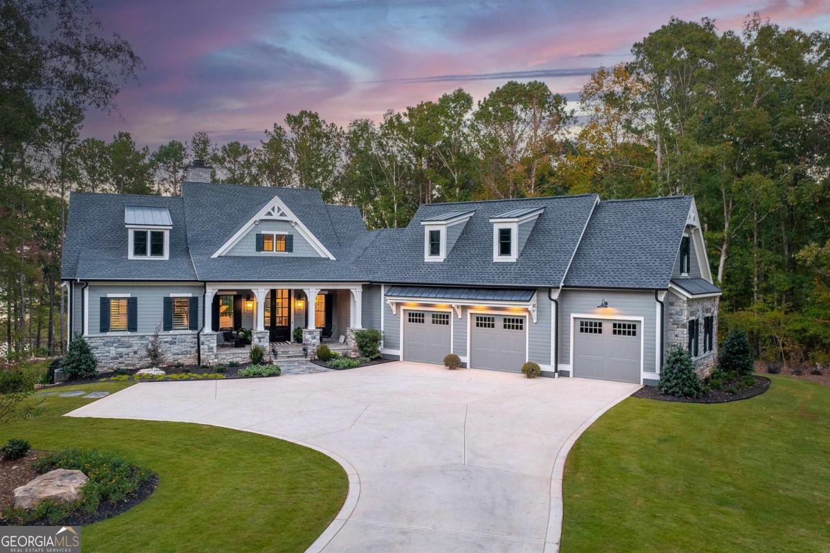 Exquisite Custom Home Overlooking Lake Oconee Nestled on a 1.45-acre flawlessly manicured lot, this magnificent custom-built home exemplifies premier craftsmanship and luxurious living. Perfectly designed to capture both sophistication and comfort, this property is a sanctuary for those seeking a home that stands apart in elegance and prestige. Welcome to Your Dream Home Experience expansive lakeside residence, featuring 4 spacious bedrooms and 3.5 meticulously designed bathrooms. Stepping through the front door, you are greeted by an airy open floor plan and soaring ceilings adorned with wood beam accents and a stunning floor-to-ceiling stone fireplace. A Culinary Haven The gourmet chef's kitchen is the epitome of luxury, outfitted with custom cabinetry and a porcelain island. It's well-equipped with premium appliances, including an adjacent wet bar complete with a Miele built-in coffee maker and a wine cooler, perfect for entertaining guests. Effortlessly extend your gatherings to the all-season screened patio through multi-slide glass doors that merge the great room and dining area with the natural beauty of the outdoors. Private Retreat The main floor is home to the stunning primary bedroom, and a spa-like primary bathroom that features timeless fittings and a custom closet tailored. Additional organized storage solutions are included in the spacious laundry and mudroom, designed with built-in cabinets and cubbies for convenience and style. Elegance Across Levels An elegant staircase leads to the terrace level, offering another open floor plan with a second captivating stone fireplace. This space hosts a versatile great room, dining area, and three impeccably appointed bedrooms. The outdoor experience continues to a summer kitchen exemplifying both functionality and beauty. Luxury Amenities The home's outdoor oasis includes a breathtaking pool with a sun deck, spa and an exquisite water feature that cascades into a Koi fish pond. Children and pets can roam freely in the fully fenced yard. The property features immaculate landscaping, meticulous flowerbeds, and a firepit. Community and Lifestyle Located in the exclusive community of Great Waters at Reynolds Lake Oconee, residents enjoy a Jack Nicolas acclaimed golf course, a premier restaurant, and a marina with concierge service. With a membership available, this home offers not just a residence, but a lifestyle. Contact me for an exclusive tour!