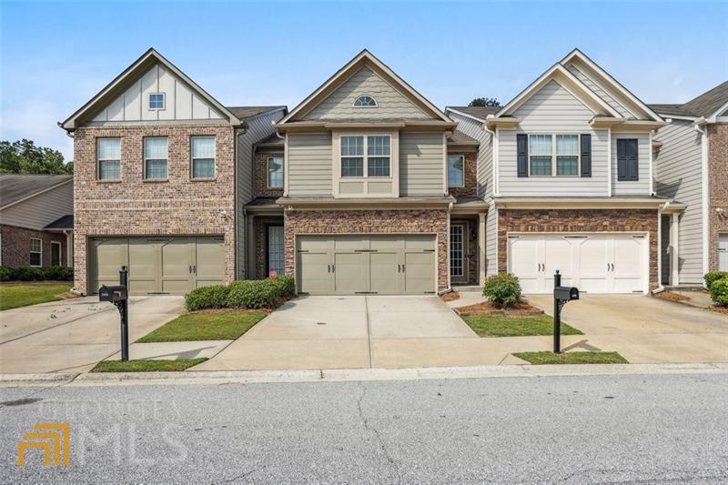 Super rare, updated 3 bedrooms, 2.5 baths, 2-story townhome with double car garage backing up to the woods. Freshly painted, new LVP flooring, new carpet and padding upstairs, updated bathrooms with marble style tile on the floor and shower. Kitchen with large sit-in island topped with a granite countertop, perimeter cabinets with granite countertop, updated backsplash, and large pantry. All stainless steel appliances. Additional large loft space upstairs - great for office, 2nd living space, or game room. Vaulted large master with walk-in closet, and master bath with double vanity and separate soaking tub and shower. Walk out to large private and fenced-in patio with upgraded patio stone pavers. Near Mall of GA, restaurants, and shopping areas. HOA fees include exterior building and road maintenance, exterior termite control, community landscaping, trash pick-up, a gated community pool, and marked walking trails through the surrounding woods for community members. Located in top rated schools in state, and NEW SECKINGER HIGH SCHOOL Opening in August of 2022.