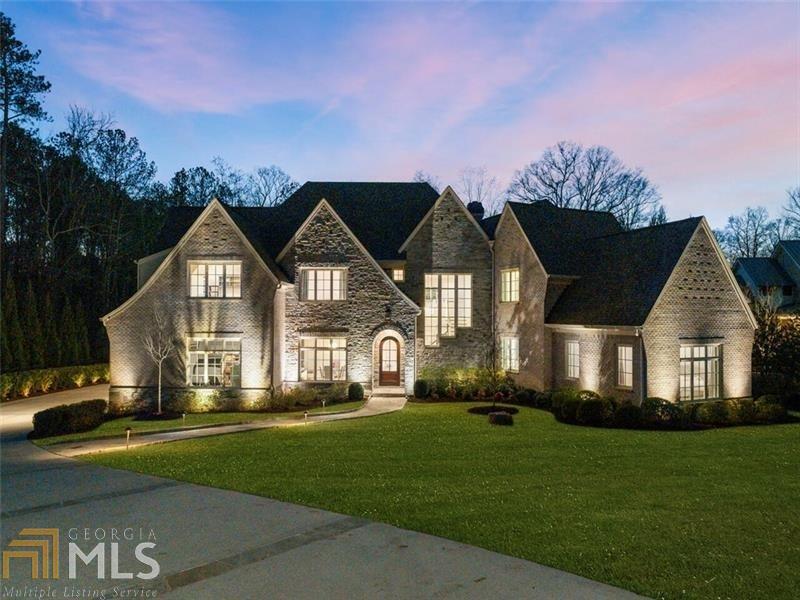 Situated on a picturesque 1.4+/- acre lot, this stunning custom home was built for entertaining on a grand scale with an effortless indoor/outdoor flow. The show-stopping kitchen features a center island with a stunning marble waterfall countertop for casual seating adjacent to the open dining area with custom steel doors leading out to the terrace. A large pantry serves as a prep area with additional appliances and extensive storage. The fireside family room invites relaxation with a custom home entertainment system. Owners' suite on the main level features an oversized bathroom with walk-in shower, luxurious soaking tub, dual floating vanities, and massive walk-in closet. Upstairs boasts 4 spacious bedrooms with private bathrooms and a bonus room. The finished terrace level is outfitted with an impressive home theater, wet bar, family room, exercise room and private guest suite. Additional enviable features include a 4-car garage, smart home technology, heated saltwater infinity pool with spa and guesthouse.