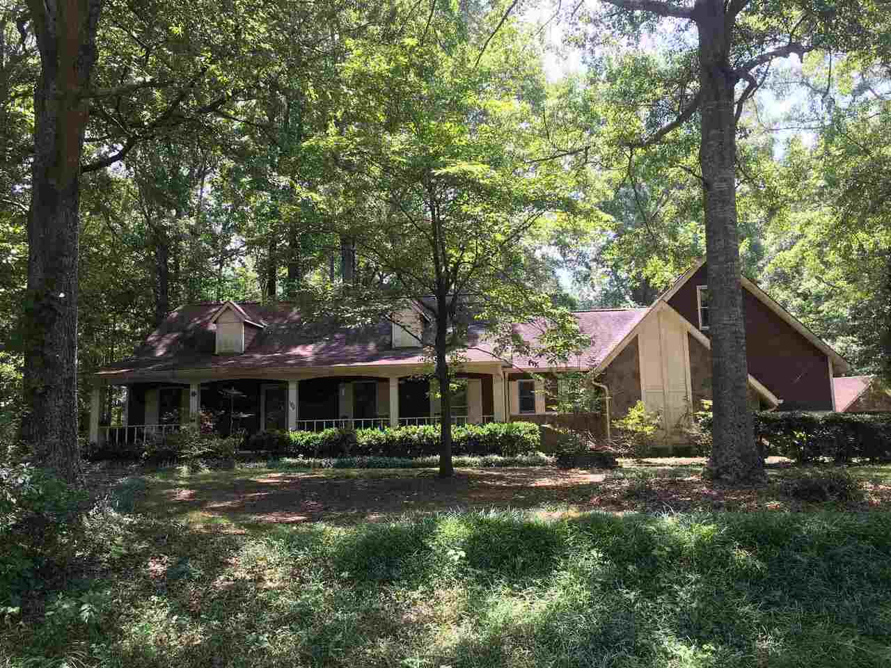 Amazing Custom Built Home on 5 acres in Moreland. Hardwood floors throughout, Kitchen has Granite counters and all stainless steal appliances, with separate dining area. Sunken living room and Large sunken master bedroom with walk in closet, New master bath with double sinks installed, April, 2021. Home has a large game room, that can be used as a teen suite or Mother In Law suite, with Butlers pantry. Very nice rocking chair front porch. Large Sunroom 9 X 17 that opens up to a very large deck with an 8 Person Hot Tub, only 2 years old, for entertaining. Beautiful inground gunite pool, also has a liner and waterfall, only 2 years old, privacy fence with a pool house, inside eating area, storage and stubbed for half bath. Huge 16 X 30 insulated workshop or mancave with power. Covered 3 vehicle carport and 1 vehicle carport, Bring Your boat and R V, plenty of parking. There is plenty of privacy, oak trees, Japanese Maples, Dogwoods, swing set and zip line for the Children. This home is a must see !