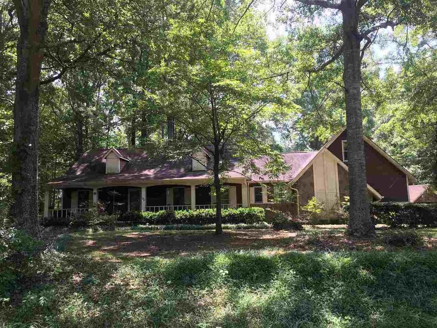 Amazing Custom Built Home on 5 acres in Moreland. Hardwood floors throughout, Kitchen has Granite counters and all stainless steal appliances, with separate dining area.  Sunken living room and Large sunken master bedroom with walk in closet, New master bath with double sinks installed, April, 2021. Home has a large game room, that can be used as a teen suite or Mother In Law suite, with Butlers pantry.  Very nice rocking chair front porch. Large Sunroom 9 X 17 that opens up to a very large deck with an 8 Person Hot Tub, only 2 years old, for entertaining. Beautiful inground gunite pool, also has a liner and waterfall, only 2 years old, privacy fence with a pool house, inside eating area, storage and stubbed for half bath. Huge 16 X 30 insulated workshop or mancave with power. Covered 3 vehicle carport and 1 vehicle carport, Bring Your boat and R V, plenty of parking. There is plenty of privacy, oak trees, Japanese Maples, Dogwoods, swing set and zip line for the Children. This home is a must see !