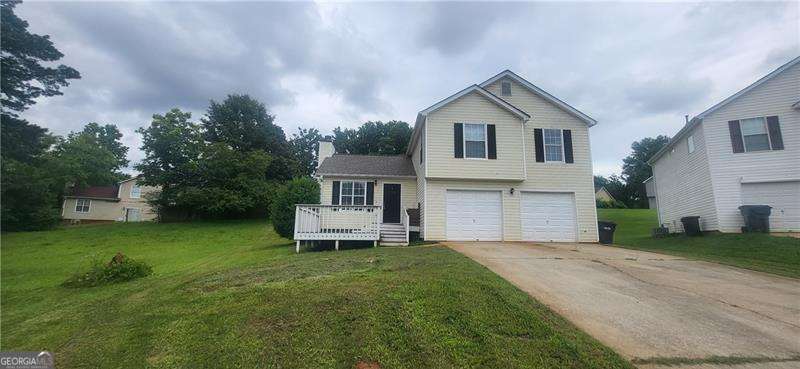 Gorgeous split level home in McDonough that's looking for new owners to call home. Located in a cul de sac lot this two garage home has both a front and back deck. As soon as you step inside you're greeted by family room with gas fireplace at the center. Tall ceilings in the family room male it light and bright with luxury vinyl plank floors and white painted walls. Private dining room in the split level can easily fit your table. Kitchen includes white cabinets, granite countertops, and stainless steel appliances. Upstairs includes primary suite with tall ceilings, double vanities, separate tub/shower and walk in closet. Two more well sized bedrooms continue upstairs and share a full bath. Deck at the back overlooks the private yard that includes fenced in portion. Located near schools, shopping, major highways and more.
