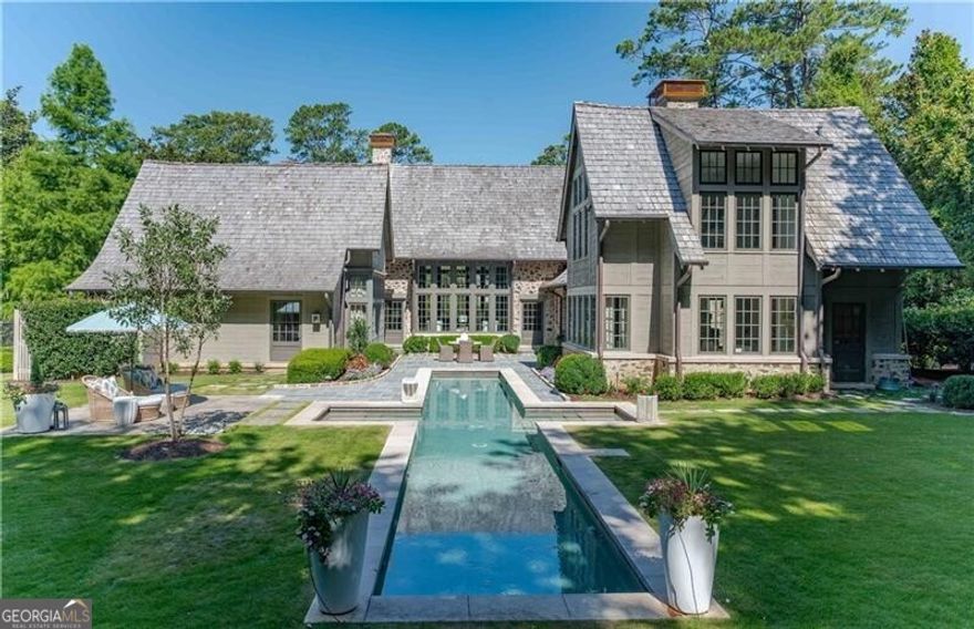 An English inspired masterpiece thoughtfully designed by architect Bobby McAlpine and Builder Shaba Derazi brings a feeling of historic charm to Buckhead. Truly no details have been left untouched in the oak floors, pecky cypress accents & limestone fireplaces. Light filled entrance foyer leads to breathtaking living room and dining room. Chef's kitchen that opens to the keeping room offers stunning wood details, oversized island and Wolf/Subzero appliances. Sought after primary suite on main hosts dual dressing areas and spa-like primary bath as well as adjoining study. The primary bath offers dual vanities, dual shower and dual water closets as well as heated floors. The manicured grounds are reminiscent of the English countryside with pool, level backyard and lush garden area on over an acre of land. The property also consists of a free standing cottage used as a pool house as well as a detached two car garage with finished space above as a guest suite. The property has geo-thermal heating and air systems and private well water serving the pool, irrigation system and home. Truly a special home on a coveted Buckhead street!