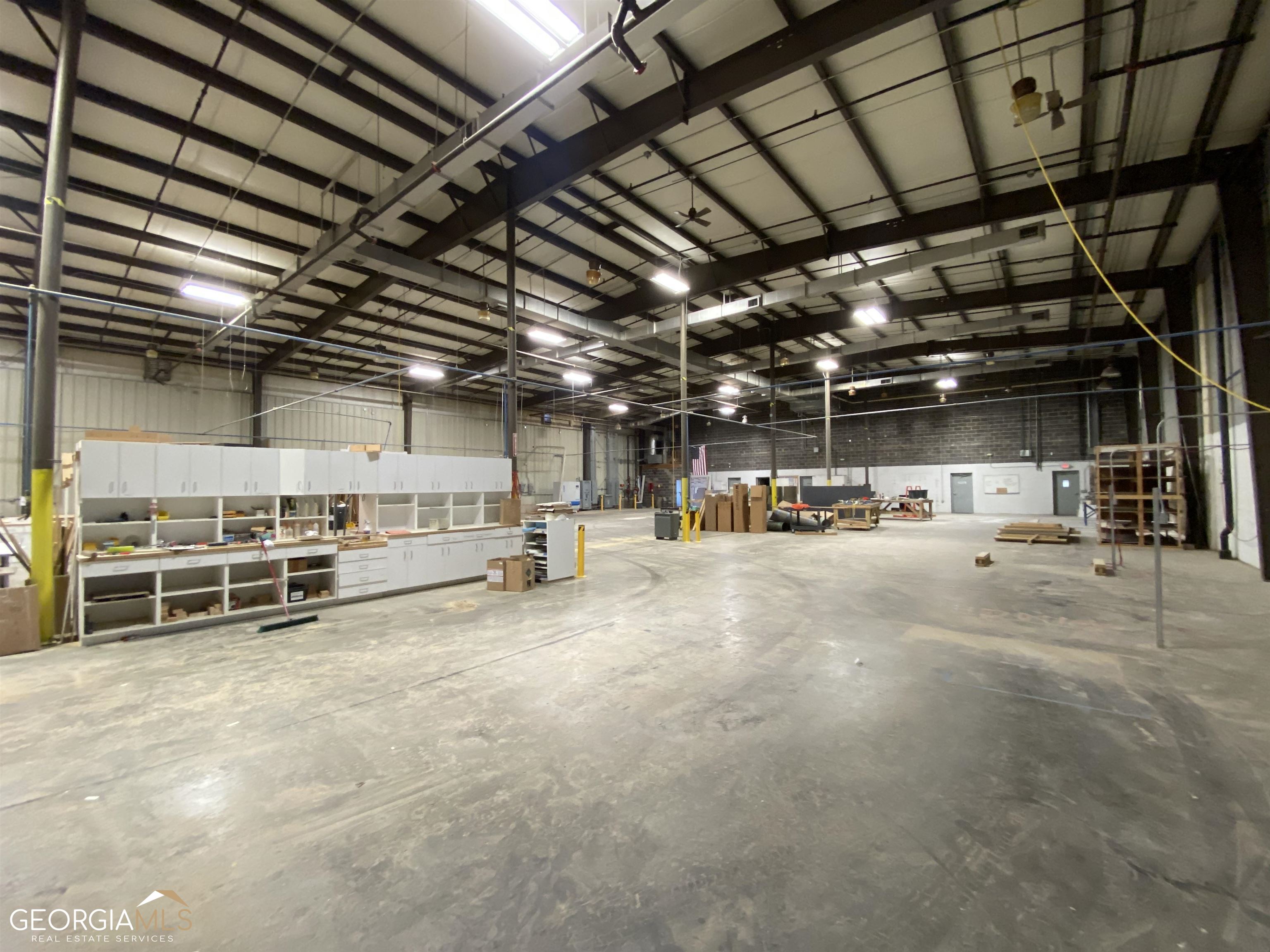 NAI Brannen / Goddard is pleased to present for your consideration a 90,000 SF industrial building / warehouse located a 255 Homer Street in downtown Commerce, GA.  The property sits minutes away from I-85 exit 147 and the SK Battery and other major industrial developments.  The building was completed in phases over the years with the main structure completed in 1959 and additions completed in the 1980s.  The property is both for sale in its entirety or for lease by the floor.  The main floor contains 65,000 +/- SF of space and the basement contains approximately 25,000 +/- SF of space.  The main floor features two demised areas that are 25,000 +/- SF and 40,000 +/- SF, respectively, of which is approximately 8,600 SF of office space.  The main floor has access to five 8' x 8' dock doors and one 12' x 16' drive-in door.  Clears are 18' - 23' and column spacing varies by section.  The basement storage area has 12' clear heights and access to four 8' x 8' dock doors.  Column spacing in the basement is 25' x 25'. The building is fully-sprinklered with heavy power on-site with ability to expand power service if needed.  There is a freight elevator connecting the main floor and basement floor.  Additional building specs and floor plans are available upon request.  Sale price for the property is $4,950,000 and the lease price varies by level.  Reach out to Otis Rylee or Mike Powell at 404-812-4000 for more information on this property.