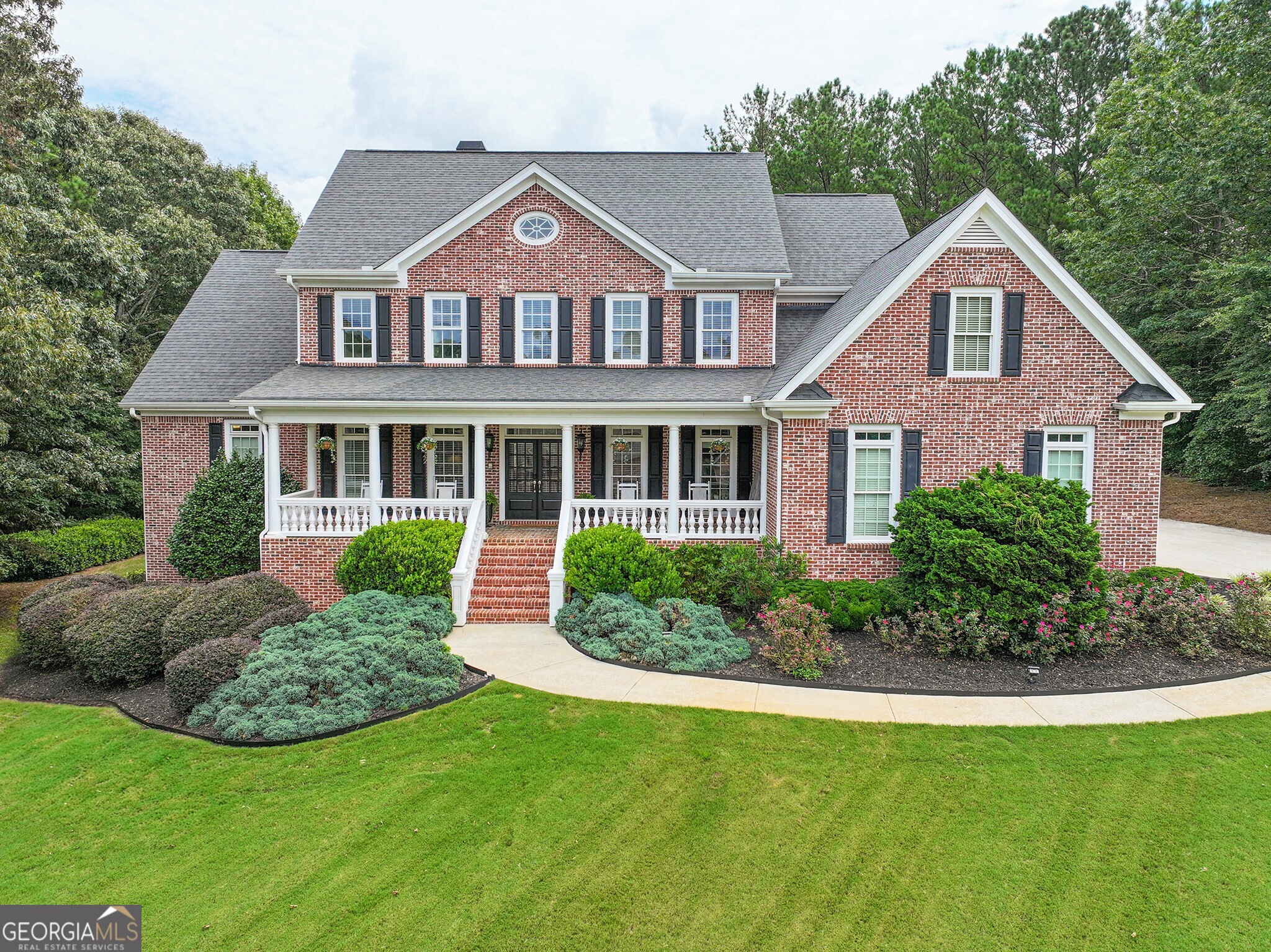 Exquisite custom estate on a private 1-acre cul-de-sac lot in an exclusive enclave of 12 homes. Four-sided brick with timeless curb appeal, lush landscaping, and an elegant front porch. Inside, a grand foyer opens to a soaring two-story great room with custom built-ins and a shiplap fireplace, flanked by a vaulted sunroom filled with natural light. The chef's kitchen dazzles with custom-painted cabinetry, a new backsplash, quartz counters, premium Dacor appliances, and a brand-new dishwasher. The main-level primary suite features a spa-inspired bath and a freshly painted retreat. Designer updates include new HVAC, Nest thermostats, new gutters, faucets, paint, lighting, Ring doorbells, and digital locks. The upper level boasts spacious bedrooms, a Jack-and-Jill bathroom with new faucets, and a bonus room. Terrace level is an entertainer's dream with new flooring, custom theater with 4K projector, surround sound, game/rec rooms, gym, and guest suite. Private backyard with pool potential. Top-rated Mill Creek schools!