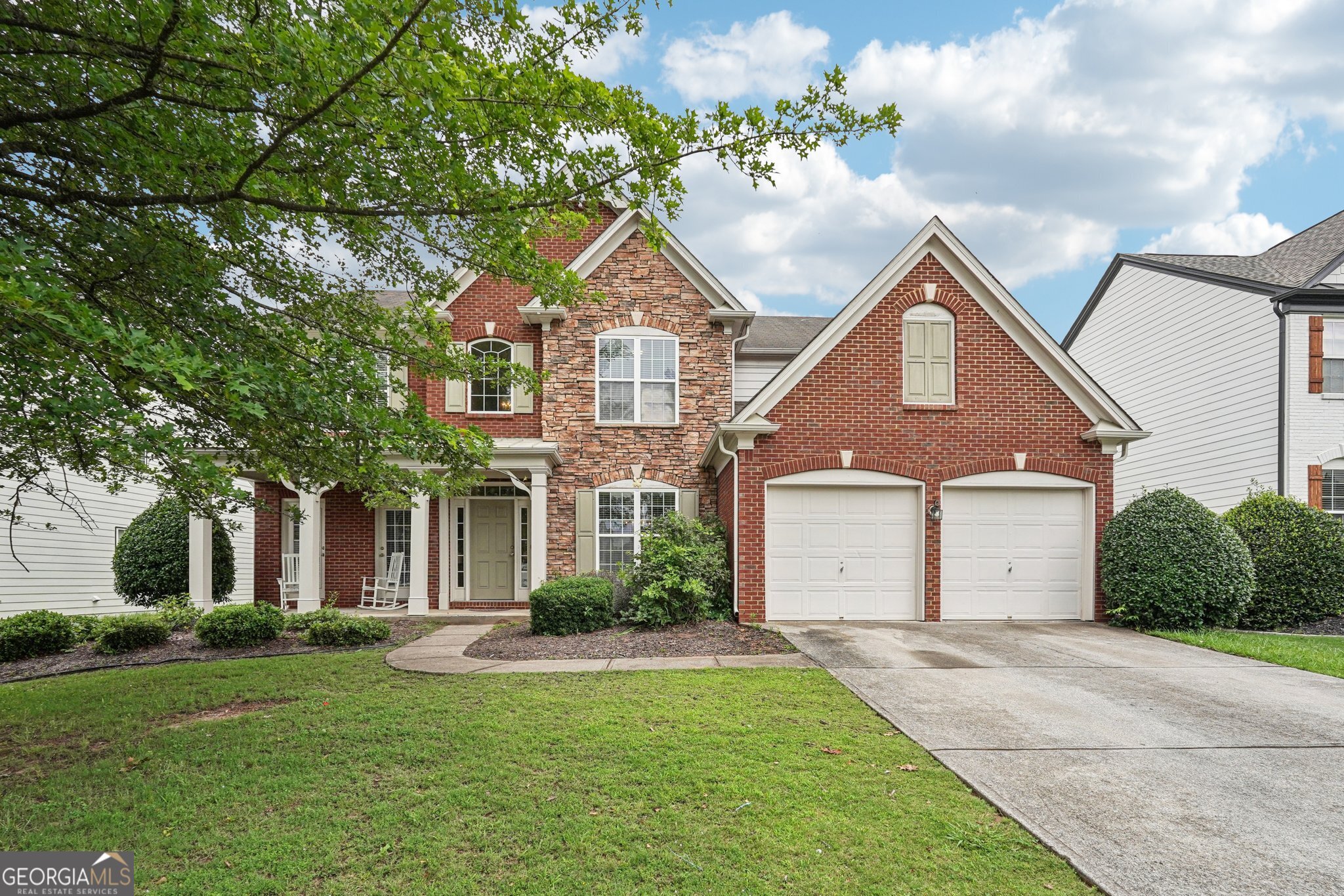 Welcome to this beautiful 5-bedroom, 3-bathroom brick home with a NEW ROOF and stacked stone accents, in a quiet cul-de-sac in the highly sought-after Woodlands community offering so much potential. Boasting nearly 3,000 square feet of living space, this home offers exceptional value, abundant space, and access to one of the area's most amenity-rich neighborhoods. The charming covered front porch provides a warm and welcoming entrance, while the two-car garage with separate garage doors enhances curb appeal and functionality. Inside, you'll find thoughtful design and impressive features, including a double sided cozy fireplace, generous storage options, and a spacious layout perfect for everyday living and entertaining with a bedroom and full bathroom on the main level! Step outside to a private patio, ideal for outdoor gatherings or quiet moments. And just in time for summer, you can take full advantage of the resort-style amenities that make Woodlands truly special, featuring a community pool with lifeguards, playground, volleyball, basketball, tennis and pickleball courts, and so much more! Even more exciting, the community has plans to expand its offerings with acres of parkland and miles of scenic walking trails, ensuring this neighborhood continues to grow in value and enjoyment. Don't wait to explore this rare opportunity to own in one of the area's most prestigious communities. With a little TLC you can live large, stay active, and enjoy the best of suburban living in Woodlands.