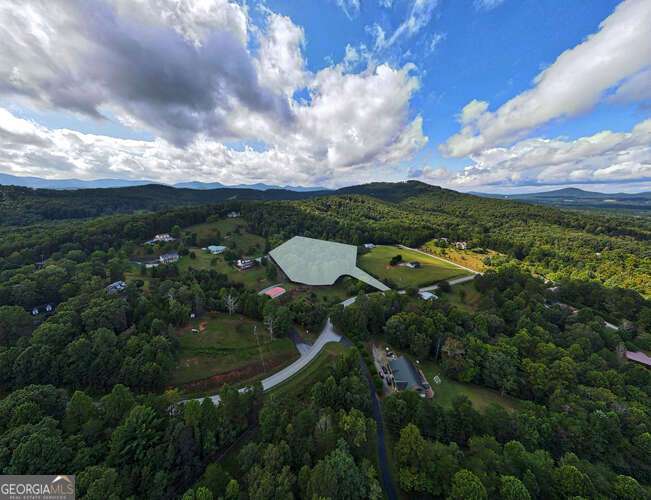 Located in the scenic mountains of Blairsville, GA, Lot 9 Northpointe Drive offers 3.3 wooded acres with year-round mountain views-an ideal setting for a full-time home, weekend retreat, or investment property. With paved road access and public utilities available, the lot offers a blend of privacy and convenience. Enjoy peaceful mornings on your porch surrounded by trees, mountain vistas, and local wildlife. Less than five miles from downtown Blairsville, you'll have easy access to shopping, dining, and entertainment, along with nearby Lake Nottely, waterfalls, hiking trails, and outdoor recreation. With close proximity to Hiawassee, Blue Ridge, and Murphy, NC, this property offers both natural beauty and excellent regional access in the heart of the North Georgia mountains.