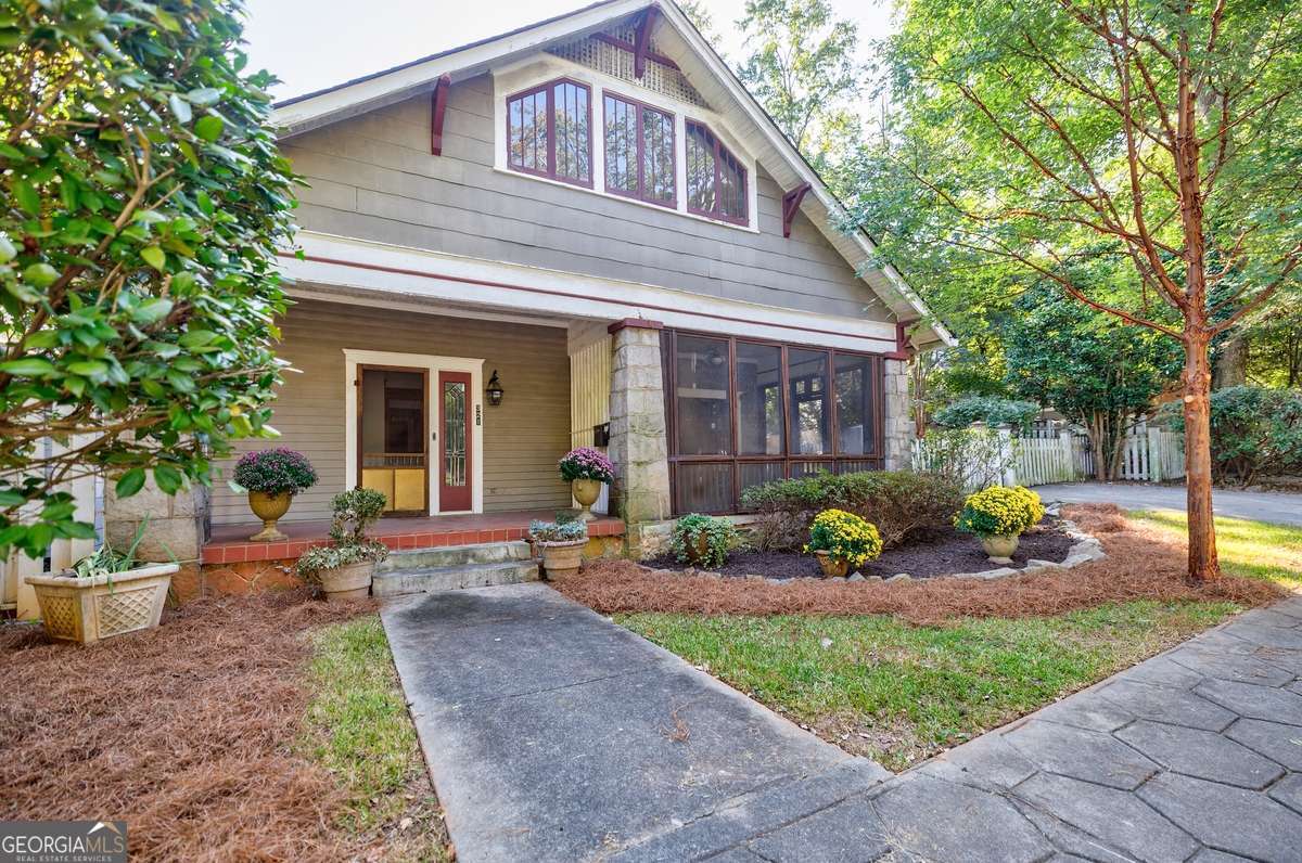 Homes like this rarely come to market. Situated on a whimsically landscaped extra wide corner lot, this historic home features original natural wood trim, boxed beam ceilings, huge dining room with wainscoting and sun filled window seat The living room with fireplace and matching built-in bookcases opens through double French doors onto a shaded front porch. Beautiful inlaid patterns grace the heart-pine floors. Upstairs you'll find two additional bedrooms and baths. The basement was excavated, steel I-Beams installed, and an expansive in-law suite added. At the rear of the home is a separately metered efficiency apartment. The perfect palette to create your Candler Park dream home is waiting for you. Renovate the existing home, add dormers or a full second story addition--the possibilities are limitless. The huge R-5 zoned lot is perfect for a future ADU with ample room left for yard and garden.