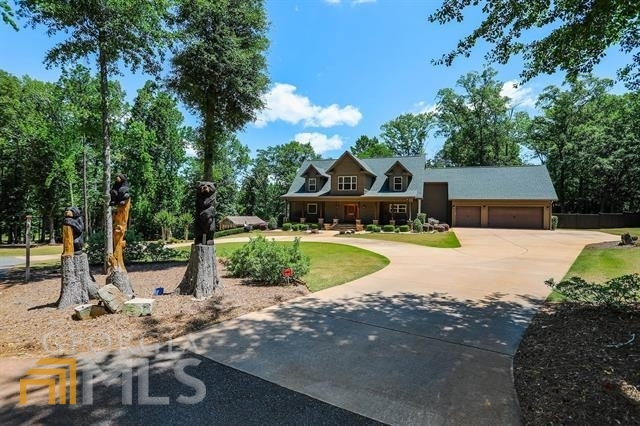 Are your looking for a pristine "one of a kind"private Secluded Log Cabin home on 40acres in Houston county GA with your onprivate Oasis bar and pool? THIS IS IT!!!From the moment you pass thru the electricprivate gate and see the carved animaltrees and the beautiful circular drive you willhave just entered your "dream"home!There is also a driveway down to the fullbasement that could be a teenager suite,sep apartment, or mother n law suite with atwo car garage. The home features a newpaved driveway 3 car garage, 2 cardetached garage, gourmet kitchen with bar,sep dining room, living room has a stackedstone fireplace wall, master bedroom onmain floor with doors that go out to deckoverlooking pool and bar area, the upstairsfeatures 3 bedrooms with a bath and thebasement has a kitchenette, living area,bedroom, bath, and theatre room, thishome was custom built and designed withnothing left to be desired! NO SIGN,PROOF OF FUND REQUIRED, DO NOTGO DOWN DRIVEWAY WITHOUT ANAPPT!