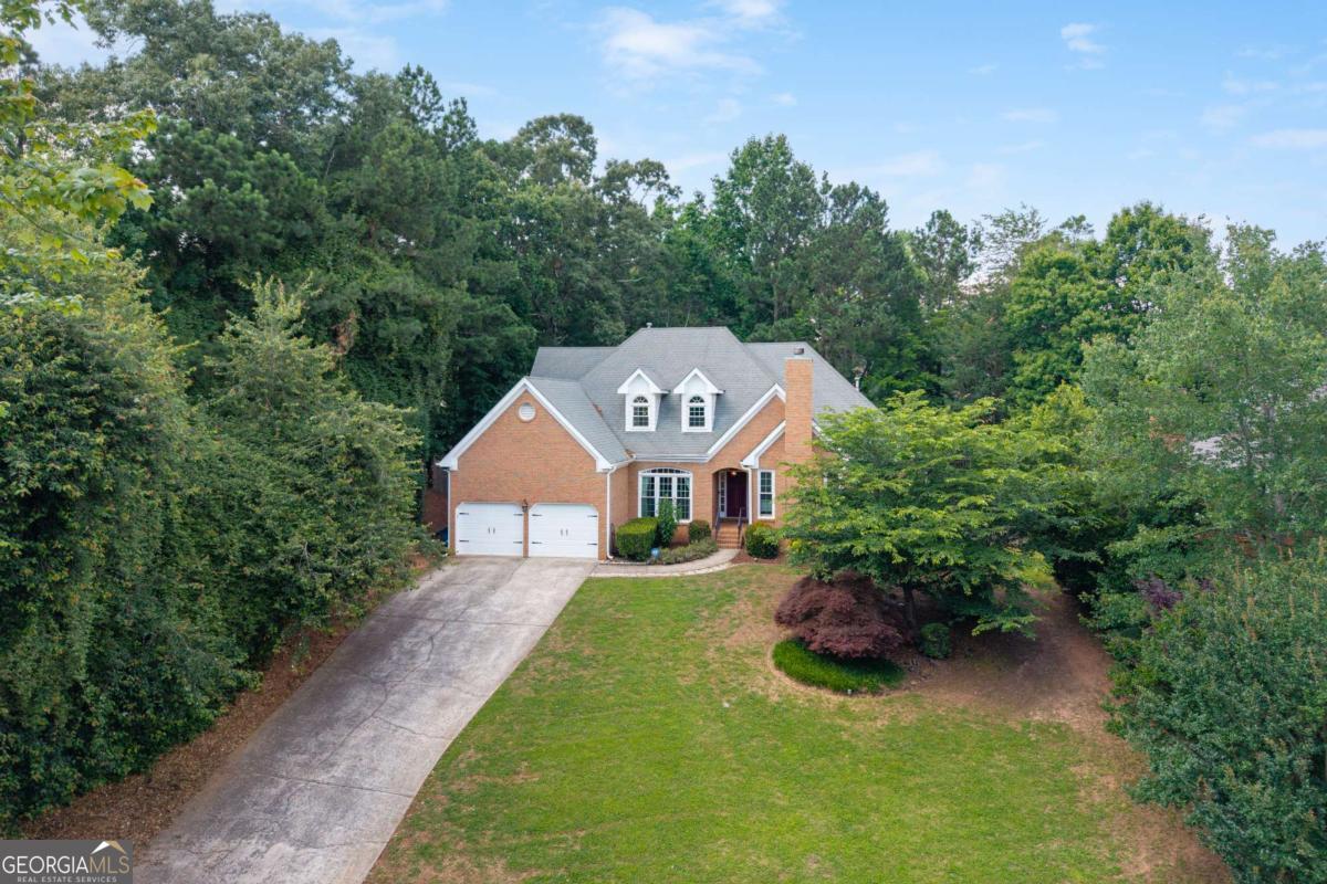 Hard to find Primary bedroom and office on main level! This beautifully updated home features hardwood floors throughout the entire main level and has been freshly painted inside and out. The elegant dining room flows seamlessly into the spacious living room, while the fireside family room opens to a gourmet kitchen complete with stainless steel appliances, granite countertops, and a sunny breakfast area. The oversized main-level primary suite offers abundant natural light, and a luxury renovated bathroom boasting new cabinetry, double sinks, granite counters, a soaking tub, and a large separate shower. Upstairs, you'll find three generously sized guest bedrooms and two fully renovated bathrooms, perfect for family or visitors. The spacious back deck has access from the kitchen and the living room, and it overlooks a flat fenced backyard.