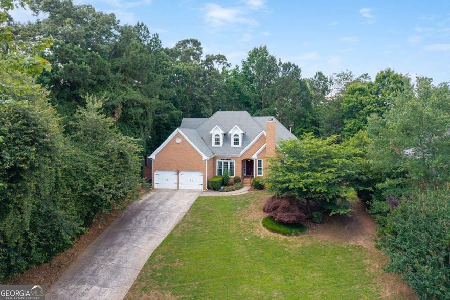 Hard to find Primary bedroom and office on main level! This beautifully updated home features hardwood floors throughout the entire main level and has been freshly painted inside and out. The elegant dining room flows seamlessly into the spacious living room, while the fireside family room opens to a gourmet kitchen complete with stainless steel appliances, granite countertops, and a sunny breakfast area.  The oversized main-level primary suite offers abundant natural light, and a luxury renovated bathroom boasting new cabinetry, double sinks, granite counters, a soaking tub, and a large separate shower.  Upstairs, you'll find three generously sized guest bedrooms and two fully renovated bathrooms, perfect for family or visitors.  The spacious back deck has access from the kitchen and the living room, and it overlooks a flat fenced backyard.