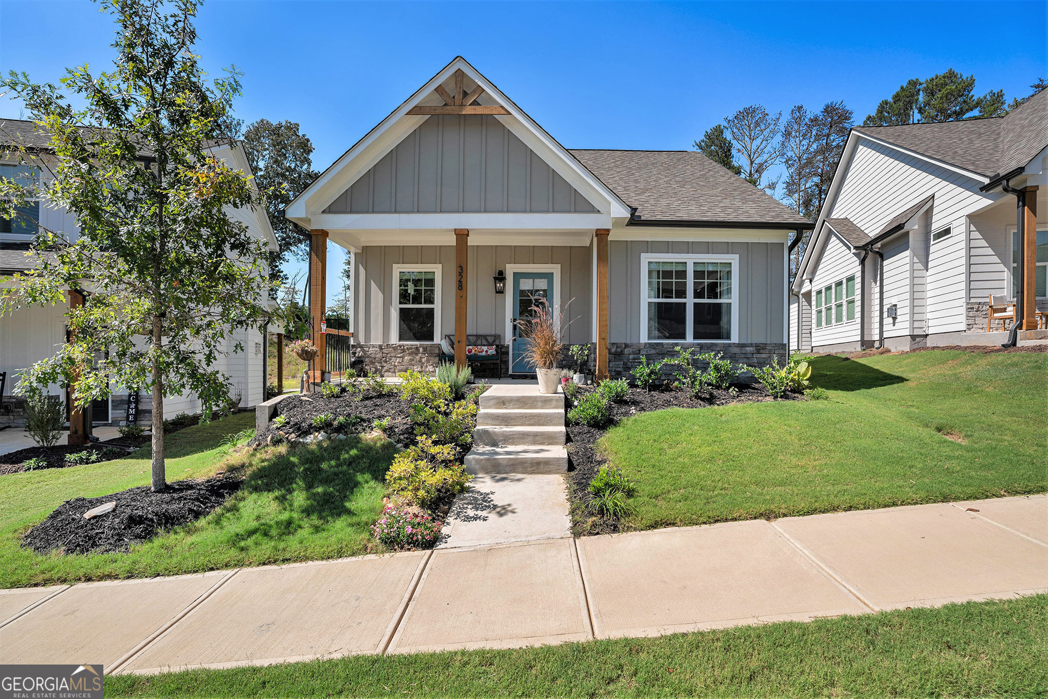 Tucked away in a peaceful community just minutes from downtown Ball Ground, this nearly new RANCH home offers modern comfort with a touch of charm. Step inside to an inviting open floor plan where the family room, anchored by a cozy gas-log fireplace, flows seamlessly into a bright, gourmet kitchen. White cabinetry, solid surface granite countertops, and pendant lighting set the stage for effortless cooking and entertaining, while the island offers the perfect spot for casual meals. The primary suite is a true retreat, featuring a spacious walk-in closet, double vanities, and an oversized shower. Luxurious vinyl plank flooring extends throughout the main living areas. Two secondary bedrooms share a thoughtfully designed hall bath. Outside, unwind on the covered front or side porch, or enjoy the privacy of a well-manicured backyard. Lush greenery, trails, a park, and a peaceful creek surround this scenic neighborhood. Plus, you're just a short stroll from Ball GroundCOs charming shops and restaurants, all within the sought-after Creekview High School District.