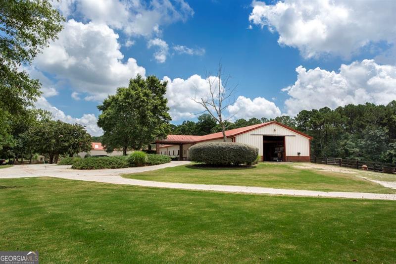 Welcome to Wisteria Farm-an exceptional 30-acre equestrian estate with powerful commercial potential and a layout ideal for a wide array of business ventures. This turnkey property is currently operating as a premier boarding and training facility, but its infrastructure and natural beauty make it a canvas for much more. Equipped with three barns offering 29 stalls, hot/cold wash racks, tack rooms, a lounge with restroom and TV, laundry facilities, and multiple fenced paddocks, this property is built for serious equestrian use. A professional 180' x 70' indoor arena and expansive 200' x 300' outdoor arena-complete with M10 footing, lights, and elevated viewing deck-support year-round training, events, or therapeutic riding programs. Additional features include an 80' round pen, bridle trails, and a derby hill. Events are currently held with ample space and parking for 200+ guests. Complementing the working farm is a beautifully renovated 2-bedroom cottage perfect for housing staff. Strategically located just an hour from Atlanta, the possibilities for this property are vast: Health and wellness retreat or rehabilitation center, Dog training and luxury boarding facility, Corporate, wedding, or event venue, Church or ministry retreat, Greenhouse or indoor farming venture, Storage or showroom for car collectors and enthusiasts. Wisteria Farm is more than land and buildings-it's a rare opportunity to own a versatile, income-generating property that can flex to meet your vision. Whether you seek a business platform, a destination retreat, or a high-end equestrian investment, this property is ready to deliver.