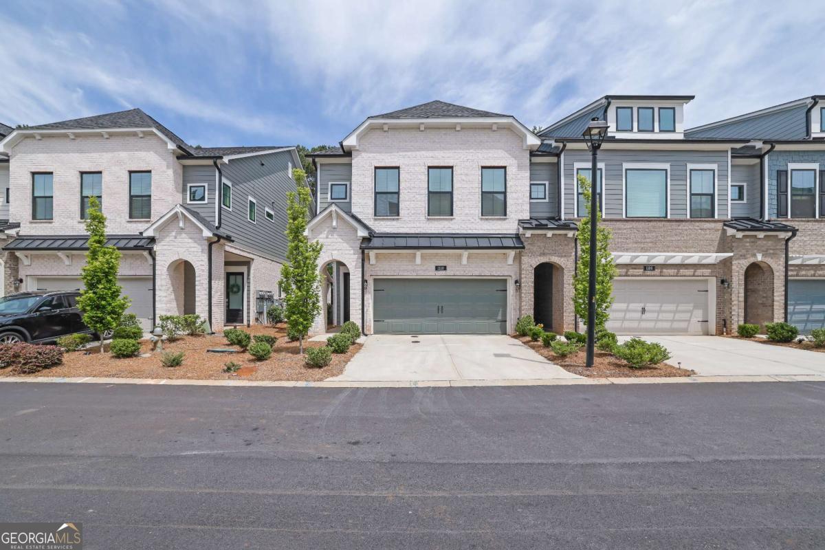 This beautiful corner lot is only 5 minutes from Canton street and downtown Roswell! It includes 3 bedrooms on the 2nd floor, 2 full bathrooms, 2 half baths, and the loft space is the entire 3rd floor, that can be utilized as an additional bedroom, a gym, an entertainment space, an upstairs office, the possibilities are endless with this top floor boasting an estimated 900 square feet with an additional area for storage on this top level. The main level features an open-concept layout with 10-foot ceilings, connecting the kitchen, dining, and living areas. The kitchen is well-equipped with a gas cooktop, stacked cabinetry (special feature), an oversized island, and curated design finishes that balance style and function. Upstairs, the owner's suite includes a sitting area and screened-in porch, with a bathroom offering a soaking tub, frameless shower, double vanity, and walk-in closet. Two additional bedrooms and a shared full bath with double sinks provide ample space for guests or family members. The outdoor covered patio and fenced yard offer additional living space, and the surrounding neighborhood is quiet and gated, with tree-lined streets and shared amenities including a swimming pool, cabana, and dog park. The location provides convenient access to downtown Roswell, Avalon, Alpharetta, and GA 400. Lastly it's in a highly rated school area which is great if you have children and useful if you ever need to sell the home in the future.