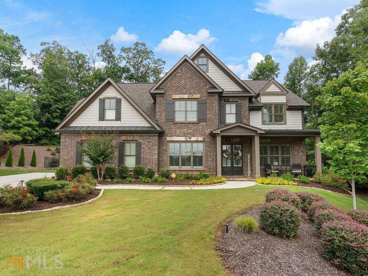 Exquisite executive home in the desirable Overlook at Marietta Country Club community. Tucked away in a large 1/2 acre, cul-de-sac lot for extra privacy, this home has a beautiful, bright, and open floor plan. The kitchen is delightful with beautiful granite countertops and a large island with generous storage. From the kitchen look out into the family room with custom built-ins and stacked-stone fireplace. The main level also features the dining room, a full bathroom, and an excellent study that can also be used as a bedroom or flex space. The large primary bedroom suite features a luxurious bath with dual vanities, soaking tub, and separate tiled shower. There is ample storage in this bathroom! The large custom closet leads right into the laundry room, how convenient! You'll find 3 other large bedrooms with walk-in closets and a jack-and-jill bath. Beautiful hardwoods throughout the home as well as fresh paint inside and out. Other features include plantation shutters, new epoxy in the 3-car garage and screened-in porch, ample storage, beautiful crown molding and trim work, fresh landscaping and landscape lighting. The showstopper for this home is when you head into the private, fenced in backyard. Passing through the covered, screened-in. porch and awesome outdoor-kitchen you are greeted with a stunning travertine terrace, hot-tub, and heated pool with a splendid water feature.