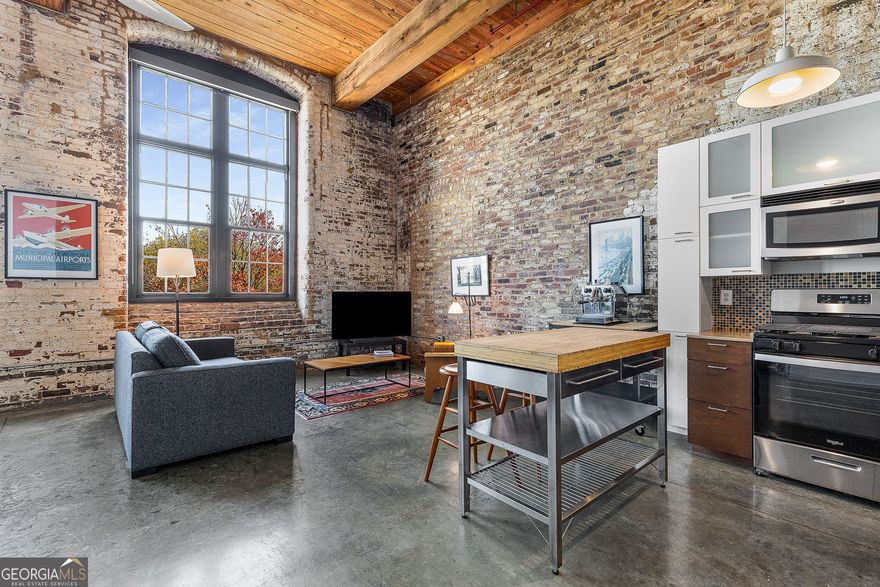 Experience true loft living in this airy, open 1-bedroom, 1-bath home featuring exposed brick walls, soaring ceilings, and oversized windows that flood the space with natural light. The generous layout includes a large closet and flexible living area perfect for both relaxing and entertaining.    Located within the iconic Stacks Lofts-a beautifully restored 1880s cotton mill-this residence blends industrial character with modern comfort. Enjoy a full suite of community amenities including a refreshing community pool, an expansive rooftop patio with stunning city views, and a free onsite gym. The community's unique mix of history, contemporary design, and updated amenities creates a vibrant, urban oasis.    All of this just steps from Cabbagetown, the BeltLine, and Inman Park. You're moments from local cafes, restaurants, and MARTA - the perfect balance of convenience, charm, and city living.
