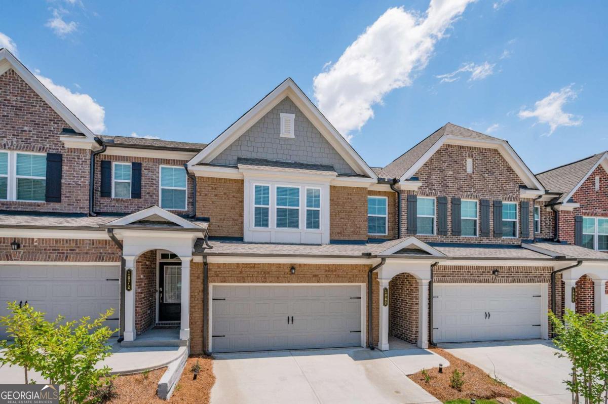 Welcome to this beautiful 3-bedroom, 2.5-bathroom townhouse nestled in the highly sought-after Carlton North community in Sugar Hill, GA. This residence offers a perfect blend of modern elegance and comfortable living in a vibrant neighborhood. As you step into this charming townhouse, you are greeted by a spacious and inviting open floor plan that seamlessly connects the living, dining, and kitchen areas. The living room is adorned with large windows, allowing natural light to flood the space, enhancing the warm and welcoming atmosphere. The well-appointed kitchen is a chef's delight, boasting sleek stainless steel appliances, granite countertops, ample cabinet space, and a convenient breakfast bar for casual dining. The adjacent dining area is perfect for hosting family gatherings and dinner parties. Upstairs, you'll find a generously sized master suite with a private en-suite bathroom that includes double vanities, a luxurious soaking tub, and a separate shower. The two additional bedrooms are also spacious and share a well-appointed bathroom. A convenient half bath on the main level adds to the functionality of this home. The townhouse is equipped with modern fixtures, ample storage, and is thoughtfully designed to cater to a comfortable and organized lifestyle. Outside, a private patio provides a peaceful retreat for outdoor entertaining or simply unwinding after a long day. The Carlton North community offers well-maintained green spaces, and various amenities for residents to enjoy. Located in the heart of Sugar Hill, this townhouse provides easy access to a plethora of shopping, dining, and entertainment options. The proximity to major highways ensures a quick commute to nearby cities and attractions. Carlton North is the epitome of modern living combined with the serenity of a suburban neighborhood, making it an ideal place to call home. Don't miss this opportunity to own a stylish and contemporary townhouse in the desirable Carlton North community. Schedule a viewing today and envision the possibilities that await you in this exceptional home.