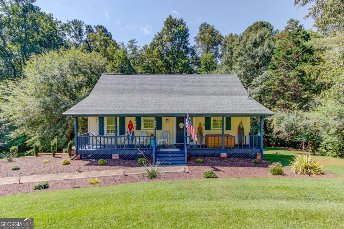 Welcome to 3754 Thompson Bend, a charming Cape Cod home located in a highly desirable North Hall neighborhood within the sought-after Mt. Vernon Elementary district. The main level features a spacious master bedroom, with two additional bedrooms and a full bath upstairs. The updated kitchen features white cabinetry and granite countertops, flowing seamlessly into hardwood floors in the family room, dining area, and kitchen. The partially finished basement is perfect for storage. Enjoy peaceful mornings on the covered rocking chair front porch in this quiet neighborhood, or unwind on the back deck overlooking a serene creek and a flat, fenced in usable backyard. Just 2 miles away, you'll find a convenient boat ramp for easy access to Lake Lanier. Just 6 minutes away from a brand new Publix, making grocery shopping quick and easy, and only 10 minutes from the Gainesville Square with plenty of shopping and dining!
