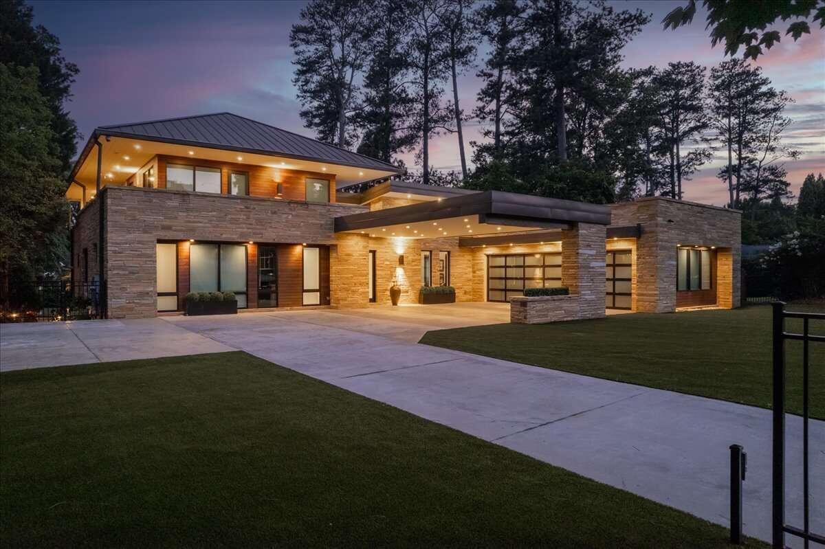 Stunning ultra contemporary home in the heart of Chastain Park. The gated property is fully turfed and lush landscaping welcomes you to a tranquil oasis. Soaring ceilings invite you into a bright, airy open concept kitchen, living and dining space. The kitchen and butlerCOs pantry feature SeiMatic cabinetry, Gaggenau appliances, new plumbing and light fixtures, and new island countertops. Designer wallpapers are featured throughout, offering a moody elegance to every space. This luxury home offers two OwnerCOs suites, one on main, overlooking a jaw dropping backyard, cabana, and infinity pool. Upstairs youCOll find a second breathtaking OwnerCOs Wing, featuring a sexy entry foyer that leads into a beautiful bedroom, complete with a private covered balcony with views of the pool. The OwnerCOs Wing offers separate His and Hers bathrooms and closets, each unique and stunning, with marble clad showers, heated floors, and gorgeous custom closets to display your shoes and bags. On the main level are three additional bedrooms and two additional full baths, tucked away from the main living areas for unique privacy. Complete with Smart Home integration for lighting, sound system, electronic blinds, and security. Enjoy the beautiful outdoor space for all seasons: a covered deck overlooking the vast backyard provides electronic screens, a new Cabana, complete with sound system and wired for entertainment, a fully turfed backyard, requiring minimal maintenance, incredible landscaping provides ample privacy as you enjoy the outdoors, and ample landscape lighting creates a beautiful evening ambiance. Electric charging in 3 car garage available. Located just seconds from all Chastain Park offers including walking trails, golf course, equestrian, swimming and sports. Just a quick drive to all the luxurious Buckhead community offers.
