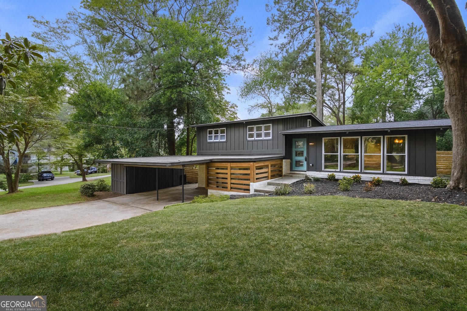Picture-perfect Mid-Century Modern! Vaulted tongue-and-groove wood ceilings with exposed beams, this fully renovated home blends timeless style with modern comfort. Redesign features all new systems and finishes: energy-efficient windows to help keep utility costs low, bathrooms, chef's kitchen, HVAC, roof, and re-routed ductwork for maximum efficiency. The designer kitchen showcases dual-tone cabinetry, quartzite countertops, stainless appliances, sleek fixtures, and a spacious island with seating and storage-perfect for cooking or entertaining. The original brick wall and wood ceilings add a chic architectural touch. Bathrooms were created to give a spa-like experience, each with beautiful tile and stylish vanities. The lower-level living area offers even more character with original brick details, a corner fireplace, Office space with a side entrance. A wet bar with a compact fridge for wine or beverages, and sliding doors opening to a covered patio offering inside/outdoor entertainment. Secured outside storage rooms. In the back of the house, enjoy an oversized, newly built patio ideal for grilling, entertaining, or adding a hot tub. The fenced, flat backyard invites pets, gardening, or play. Located in the Lakeside High School district, this home provides easy access to interstates, Emory University, CDC, CHOA, St. Pius, and all the amenities of the Northcrest/Tucker area. Don't miss this turnkey Mid-Century Modern masterpiece. Details have been thoughtfully designed for stylish, worry-free living!