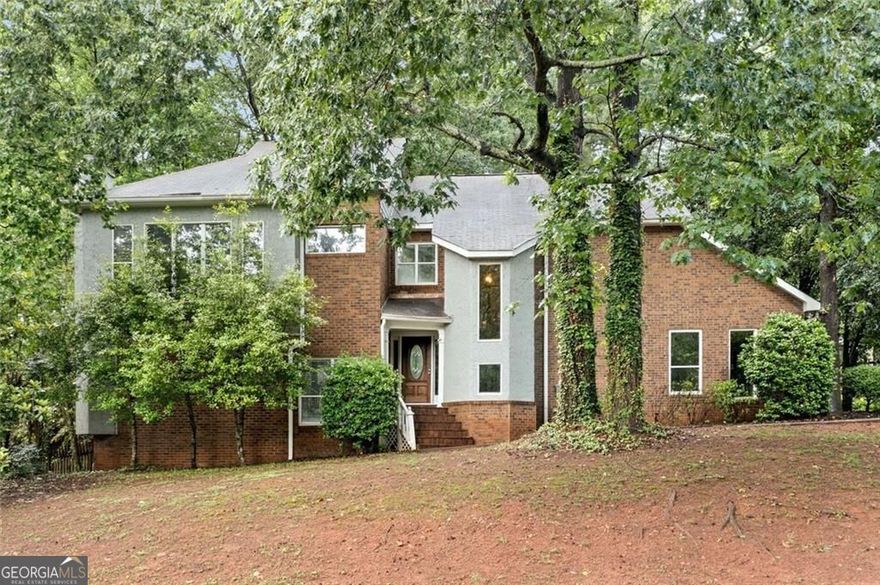 Welcome to Your Next Chapter Near Downtown Roswell.  In a tranquil neighborhood, this four-bedroom home is just a few minutes from historic Roswell and the Mill. There's plenty of potential here, waiting for you to add your touch.  As you step inside, you'll find a cozy sunken living room centered around a gas-start corner fireplace. Just a few steps away, the spacious dining room offers the perfect gathering space, with open views to the living room and easy access to the kitchen.  The bright kitchen is filled with natural light, thanks to its generous windows overlooking the fenced backyard. It's a space that's perfect for both morning coffee and lively dinner prep.  Upstairs, the vaulted primary suite feels like a true retreat, complete with a spacious en suite bath and walk-in closet. Three spacious secondary bedrooms provide flexibility. One features direct access to a bathroom with double vanities and sleek, modern finishes, while the other two share a convenient access from the hallway.   Downstairs, the walkout basement is a blank slate. It's already set up for a bathroom and ready for your ideas. You could create a media room, a guest suite, or a home gym.  This is more than just a house - it's the start of a new chapter in one of Roswell's most sought-after areas. Come make it your own.
