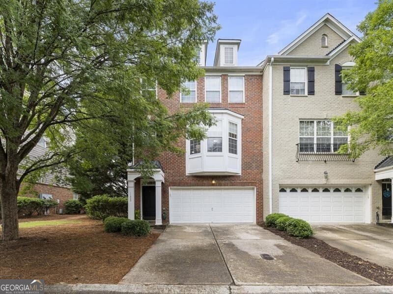 Discover the epitome of modern suburban living in this end-unit brick townhome in the Westside Villas community, ideally situated in a prime Alpharetta location. Enjoy the utmost convenience with proximity to restaurants and retail in downtown, the Avalon and North Point Mall, and nearby attractions such as the Ameris Bank Amphitheatre, Top Golf, and Fetch Dog Park. Benefit from residing within the acclaimed Milton school district, take advantage of the serene trails of Big Creek Greenway and the Alpha Loop, and commute effortlessly with quick and easy access to GA-400. This townhome boasts an open and airy floor plan highlighted by great natural light and gleaming wood floors throughout most of the main level and downstairs. The kitchen features high-end stainless steel Samsung appliances and overlooks the adjacent family room that welcomes with an inviting fireplace. This unit is also one of very few in the neighborhood with a sunroom, a versatile space that can serve as a home office, play area or additional sitting room, and the back deck offers an ideal spot for outdoor relaxation. Upstairs, the primary suite promises tranquility with a generous walk-in closet and a private, updated bathroom featuring a spacious frameless shower. Additional bathrooms throughout the home have also been tastefully renovated to feature large showers, enhancing both style and functionality. The terrace level expands the home's versatility with a full bathroom and a flexible bonus space adaptable as a guest retreat, media room, home office or gym - offering endless possibilities to suit your lifestyle. Convenience continues with a 2-car garage for easy parking and storage. Don't miss the opportunity to make this sophisticated end-unit townhome your own and experience Alpharetta living at its finest.