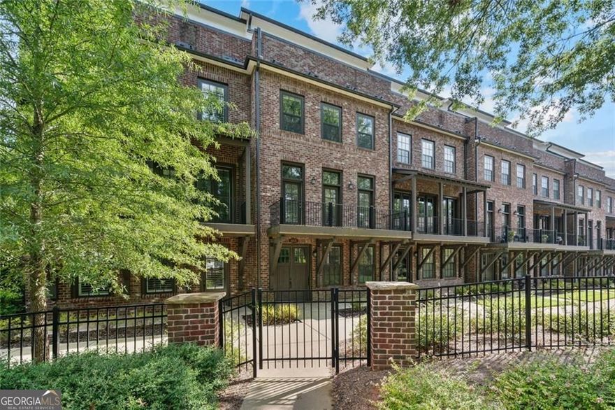 Discover a like-new pristine townhouse in the heart of East Cobb, offering a lock-and-go lifestyle with ultra-low maintenance. This four-level home features four bedrooms, a bonus room, and four and 1 half baths across 3,336 square feet of premium living space. Sunlight pours through oversized windows, highlighting designer finishes at every turn and creating an inviting atmosphere from the moment you enter.  Private Elevator services all floors for effortless living and entertaining. Two-car-attached garage with direct foyer access provides ultimate convenience at an entry level, which also features an ensuite secondary bedroom.   Main level features a Chef's kitchen with floor-to-ceiling designer cabinetry, quartz countertops, extra-large island and premium stainless-steel appliances perfect for culinary enthusiasts. Gather in the kitchen's keeping room or enjoy the adjacent sunroom with access to the back deck creating seamless indoor-outdoor flow for casual brunches or evening cocktails. Expansive open floor plan in the Family room on the main level featuring 10-foot ceilings, rich hardwood floors, a wall of windows with access to the front balcony and a statement fireplace anchoring the gathering room. Third level features a luxurious primary suite with double-vanity, separate soaking tub and large walk-in shower, and ample walk-in closet allowing you to enjoy a spa-like retreat.  Laundry room and additional second bedroom with ensuite bath are also on 3rd level. Fourth Floor offers a great bonus room that could be used as a game room, second family room or office, plus an additional secondary bedroom with ensuite bath, plus access to private rooftop sky terrace offering treetop views - your ideal spot for morning coffee or starlit gatherings.  Located next to the Olde Towne Athletic Club high-end tennis /pickleball/swim facility, perfect for fitness lovers and social play. Quiet, friendly community where neighbors become friends, blending exclusivity with genuine small-town warmth. Situated minutes from grocery, boutique shopping, chef-inspired eateries, and top-rated Walton HS, this home balances tranquility with access to Atlanta, Sandy Springs, and Downtown Roswell. Whether you're commuting to work or exploring the vibrant local scene, you're never far from the best that metro Atlanta has to offer.