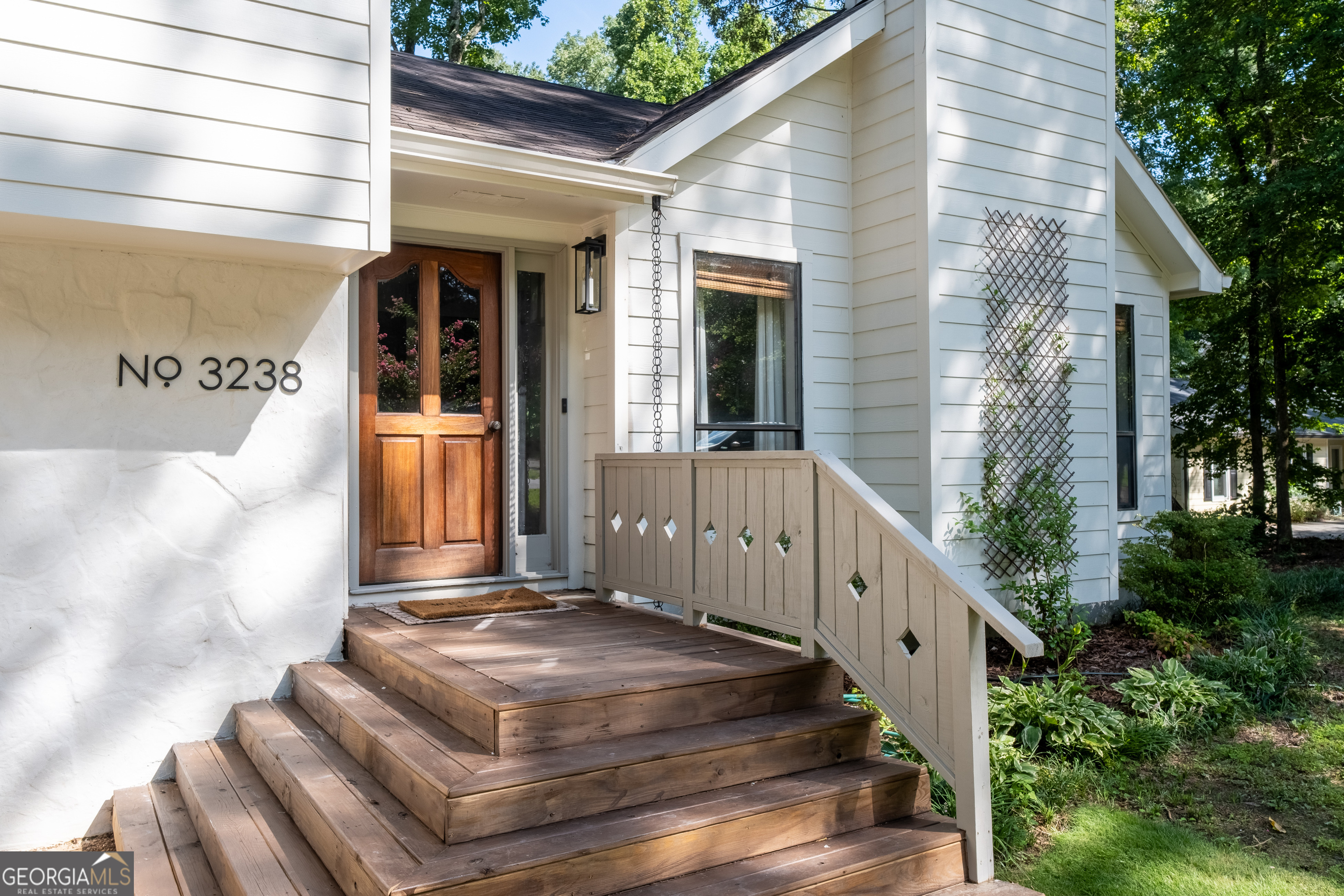 Welcome to 3238 Mountain Hollow Drive, a beautifully updated 5-bedroom, 3-bath home where every detail has been thoughtfully curated by a professional interior designer. From the moment you step inside, you'll notice the elevated finishes, on-trend color palette, and upscale lighting package that set this home apart. Enjoy real hardwoods throughout the open-concept layout, soaring vaulted ceilings in the main living area, and an abundance of natural light. The heart of the home is the modern kitchen featuring top-of-the-line appliances, sleek countertops, and seamless flow into the dining and living spaces - perfect for both entertaining and everyday living. Step outside to your level, fully fenced backyard - an entertainer's paradise with plenty of space for pets, play, and weekend gatherings. Bonus: the expanded gravel driveway offers extra parking, ideal for guests or multi-driver households. There's room for everyone to spread out in comfort. Located in the sought-after Lassiter High School district, with Simpson Middle and Rocky Mount Elementary nearby, this home offers the perfect blend of style, space, and top-tier schools. Don't miss this East Cobb gem - move-in ready and designer-approved!