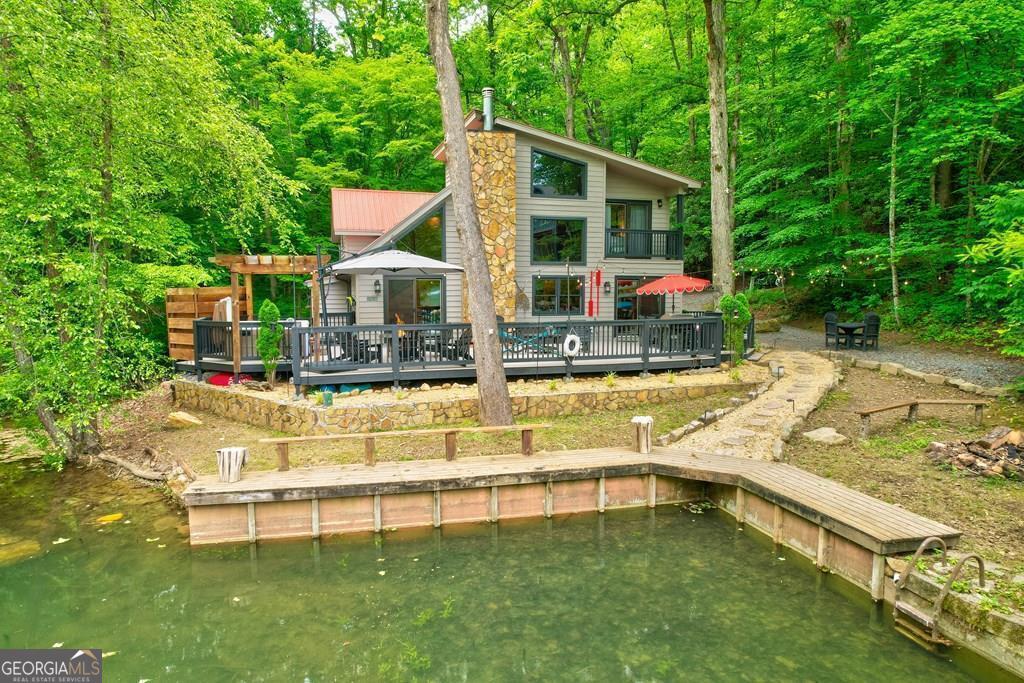 Affordable, ADA-accessible Lake Blue Ridge chalet with year-round creek frontage and panoramic lake views. Vaulted ceilings, modern appliances, EV charger, boat dock and expansive decks with premium outdoor furniture set the scene for effortless lakeside living. Unwind in the new hot tub, by the fire pit, or rinsing off in the rustic outdoor shower. Just minutes from the Aska Adventure Area and downtown Blue Ridge's shops and restaurants, this turnkey retreat even serenades you with creek sounds at your master-suite sliding doors. Schedule your showing today!