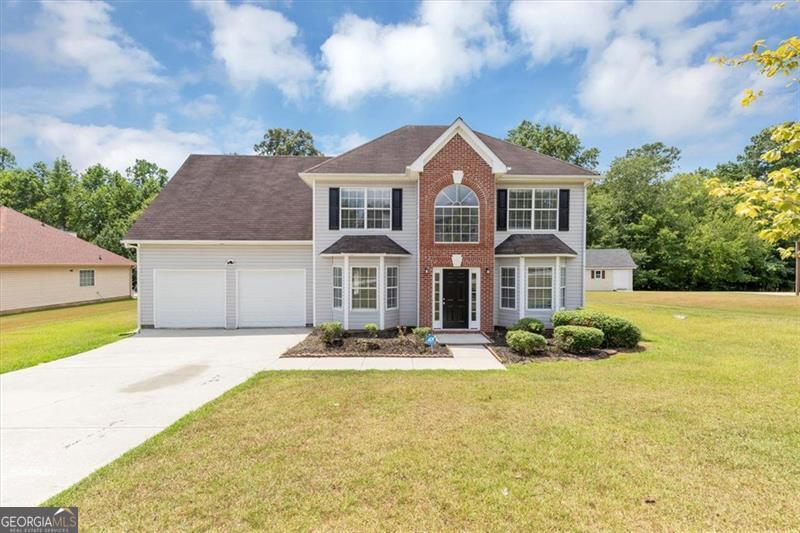 Charming curb appeal and classic brick-and-siding exterior welcome you to this beautifully maintained home in a prime Snellville location! Set on a spacious lot with manicured landscaping, this home offers a huge yard and a finished 2-car attached garage. Inside, you'll find vaulted and coffered ceilings, upgraded crown molding, and chair rail accents throughout. Abundant windows fill the home with natural light, while bay windows in the formal dining room and den add character and charm. The kitchen features a separate breakfast nook, solid-surface countertops, and a large pantry. Separate laundry room for added convenience. The cozy family room includes a fireplace and ceiling fan for year-round comfort. Conveniently located near shopping, dining, and major routes-this home blends timeless style with everyday functionality.