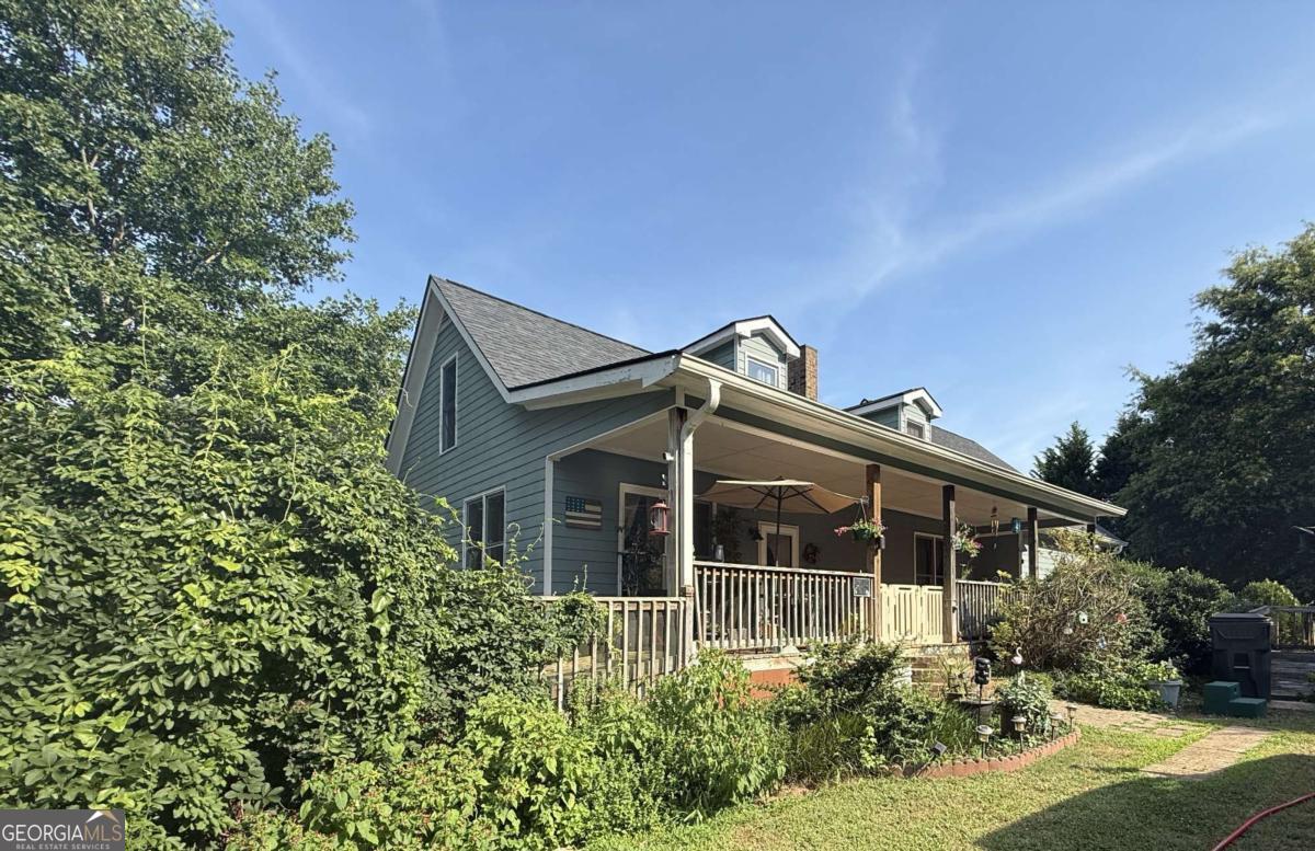 Charming 5-Bedroom Country Retreat on 9.68 Usable Acres with Horse Facilities & Possible Development Potential! Welcome to your private slice of countryside living! Nestled on a quiet, scenic road where nature abounds, this 5-bedroom, 4-bathroom home offers space, character, and endless potential-whether you're an equestrian enthusiast, or a builder with a vision. Set on a stunning 9.68 acres of flat, fully fenced land of road frontage, this property combines privacy with accessibility. The grounds feature a tranquil pond, mature trees, and expansive pastures currently home to four horses. For equestrians, the 8-stall horse stable with a dedicated tack room is ready for your horses or boarding business. A 2-car detached garage plus ample additional parking ensures space for trailers, guests, and recreational vehicles. Inside the home, you'll find charm and flexibility at every turn. The main level features 3 spacious bedrooms, a cozy third bedroom perfect for a home office, and two fireplaces-one warming the inviting family room and another adding comfort and ambiance to the master bedroom suite. Upstairs, enjoy finished attic space-a versatile area ideal for a large bedroom, game room, creative studio, or additional living space. The unfinished basement offers even more storage or workshop potential. Whether you dream of a hobby farm, multi-generational living, or future development (builder's dream with its wide frontage and acreage), this property offers the rare combination of space, functionality, and natural beauty. Don't miss this unique opportunity to own a special property where lifestyle and potential come together.