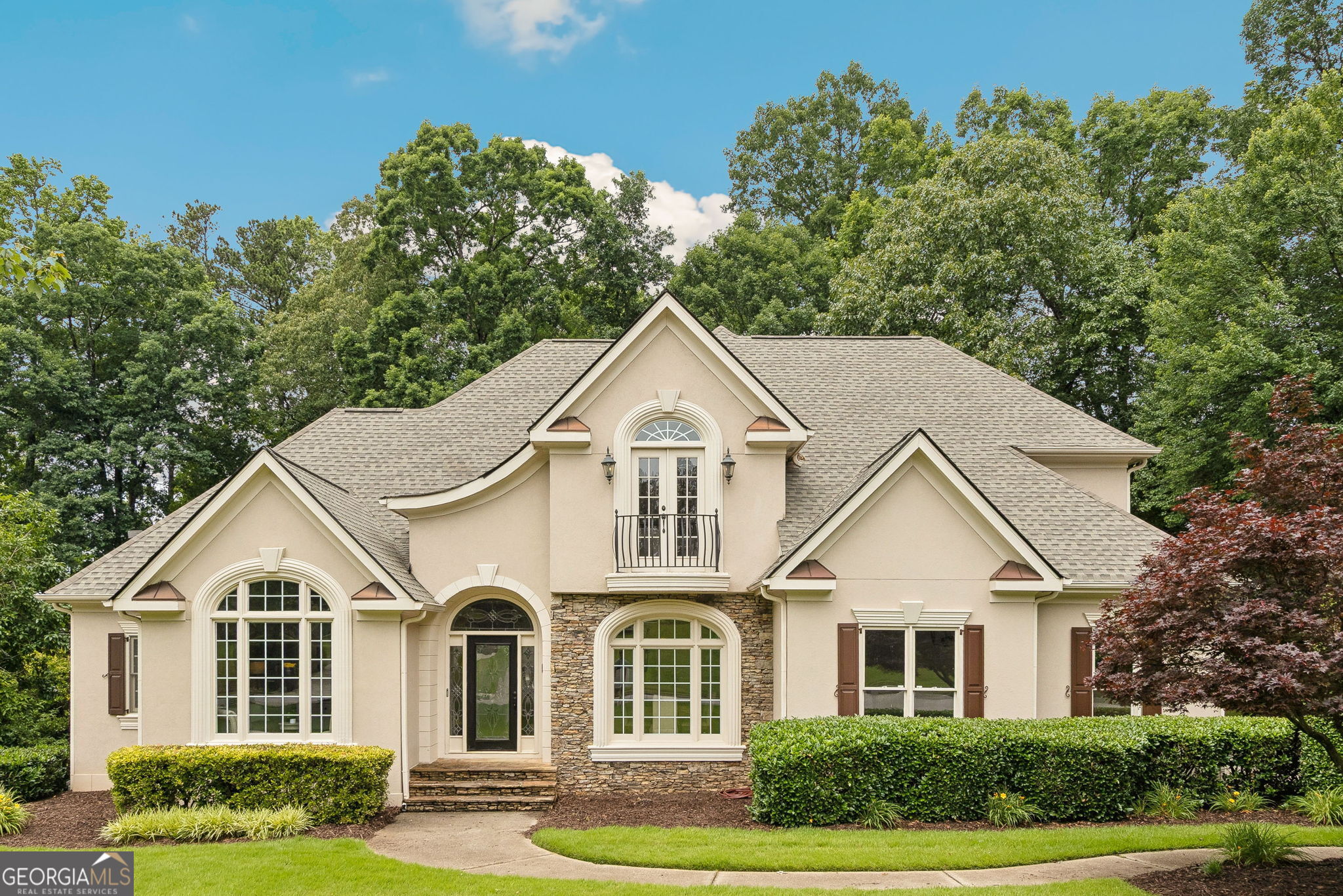 Welcome to the stunning former model home of Deerlake Subdivision in Awesome Alpharetta! Enjoy all the builder extras including gorgeous, extensive trim work and molding, smooth ceilings & recessed lighting thru-out! All rooms are light & bright with lots of windows offering natural sunlight! The entry features a custom leaded glass front door, sidelights & transom! Located on the main level you will find the Luxurious Primary Suite finished with a double-tray ceiling, a recently remodeled, spa-style retreat Bathroom, a large walk-in shower with pebble reflexology flooring, an extra large Kohler designer soaking tub, a double vanity & 2 walk-in Closets with built-in shelving! The Main floor Kitchen offers a wine refrigerator, a NEW full-size Refrigerator with custom ice drawers, a NEW cooktop and dishwasher, granite countertops, a deep sink, a large walk-in pantry & an open layout! The ceilings soar in the two-story foyer & living room with a glowing and cozy fireplace! The Den/Office is located off the main foyer with Built-ins cabinets and a large picture window and transom! The dining room is appointed with modern lighting, French paneled walls and a picturesque view of the front yard through the large double window and transom. At the side entry there is a mud/laundry room with a large utility sink. Upstairs you will find a large Ensuite guest Bedroom and 2 additional Bedrooms with a connected bath. All bedrooms enjoy spacious walk-in closets! Hardwood floors adorn the main level while the well appointed terrace level is finished with custom Italian porcelain tile and features a large, custom built Wine Cellar holding approximately 850 bottles and includes a granite pouring/tasting station. Also on the terrace level you'll find a large kitchenette and bar, a full bath and an entertaining/TV area with a billiard table & fireplace all opening to your covered patio and private back yard! The Newer roof was installed in 2022! The heating units were replaced in 2023. The main double garage has an epoxy floor, wainscoting with an insulated door and a "quiet" Belt-Drive Lift Master opener with "MyQ" Smart App Technology! There is a wrap-around driveway to the oversized 3rd car garage with tandem parking and a built-in workshop! Plenty of storage throughout that includes 2 attic access points! The front and rear yards have an inground irrigation system! This exterior of the home is finished with hard-coat stucco! The fabulous Deerlake community is golf cart friendly and enjoys a gated main entry and excellent community amenities including a Clubhouse, Olympic-size pool, fun children's pool, 6 tennis/pickleball courts, a basketball, a tot lot, golf cart parking, and a scenic lake with a beautiful fountain and fishing pier! Close to shops & restaurants! Deerlake is located in Beautiful Forsyth County and enjoys Forsyth County taxes.